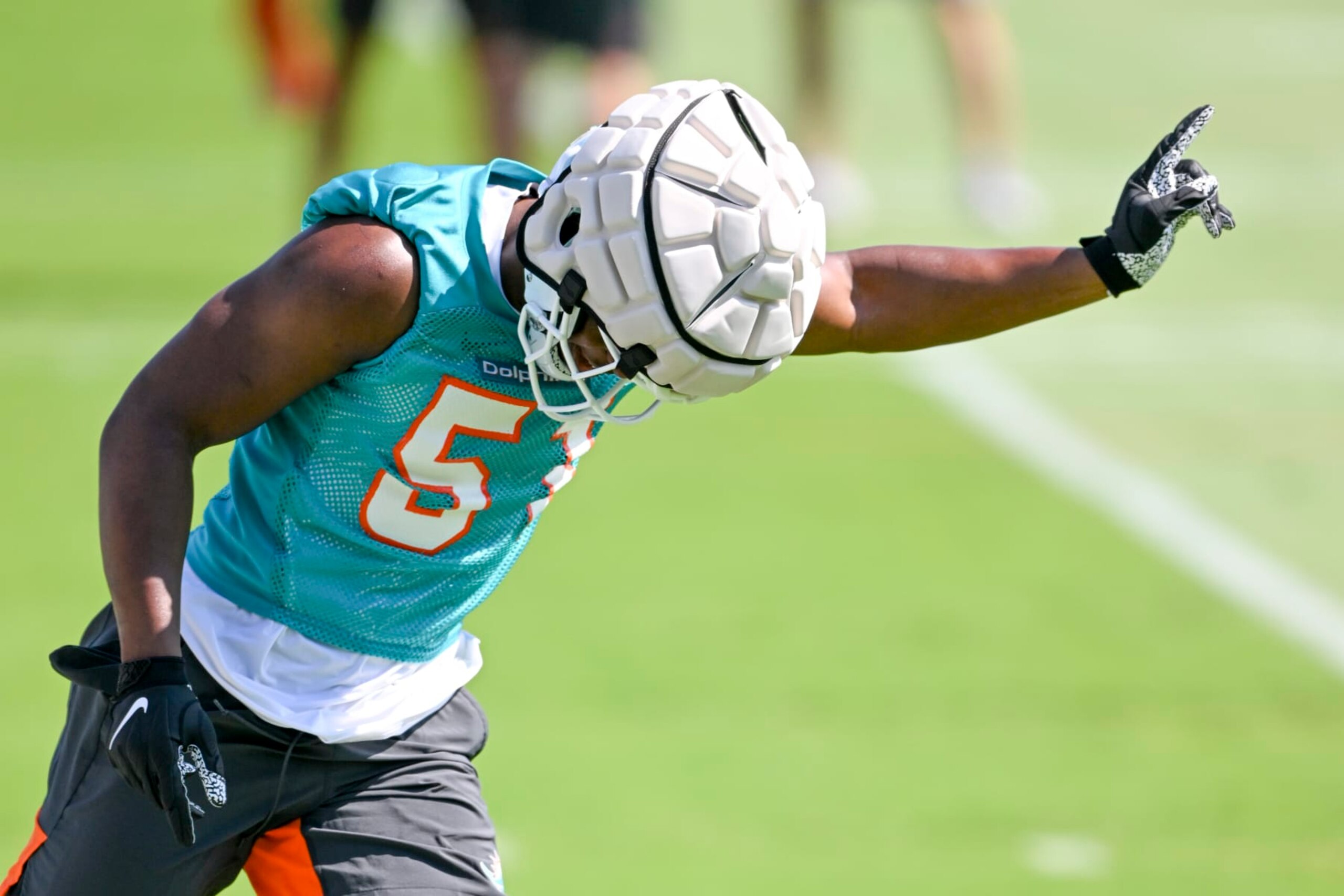 MIAMI GARDENS, FL - MAY 14: Miami Dolphins linebacker Channing Tindall (51) gestures as he runs a drill during the rookie minicamp at the Baptist Health Training Complex on May 14, 2022, in Miami Gardens, Florida. (Photo by Doug Murray/Icon Sportswire via Getty Images)