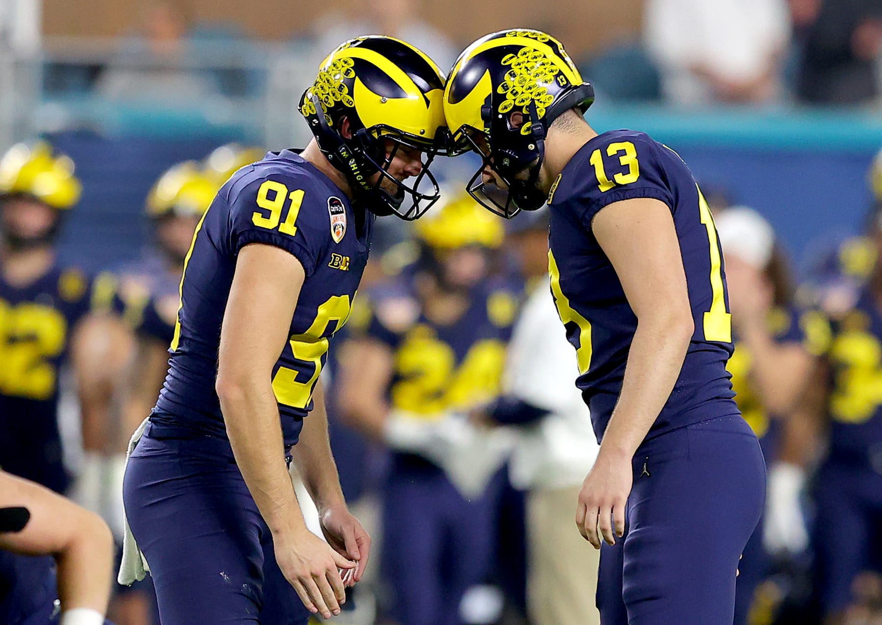 MIAMI GARDENS, FLORIDA - DECEMBER 31: Jake Moody #13 of the Michigan Wolverines reacts after scoring a field goal with teammate Brad Robbins #91 in the second quarter of the game against the Georgia Bulldogs in the Capital One Orange Bowl for the College Football Playoff semifinal game at Hard Rock Stadium on December 31, 2021 in Miami Gardens, Florida. (Photo by Kevin C. Cox/Getty Images)