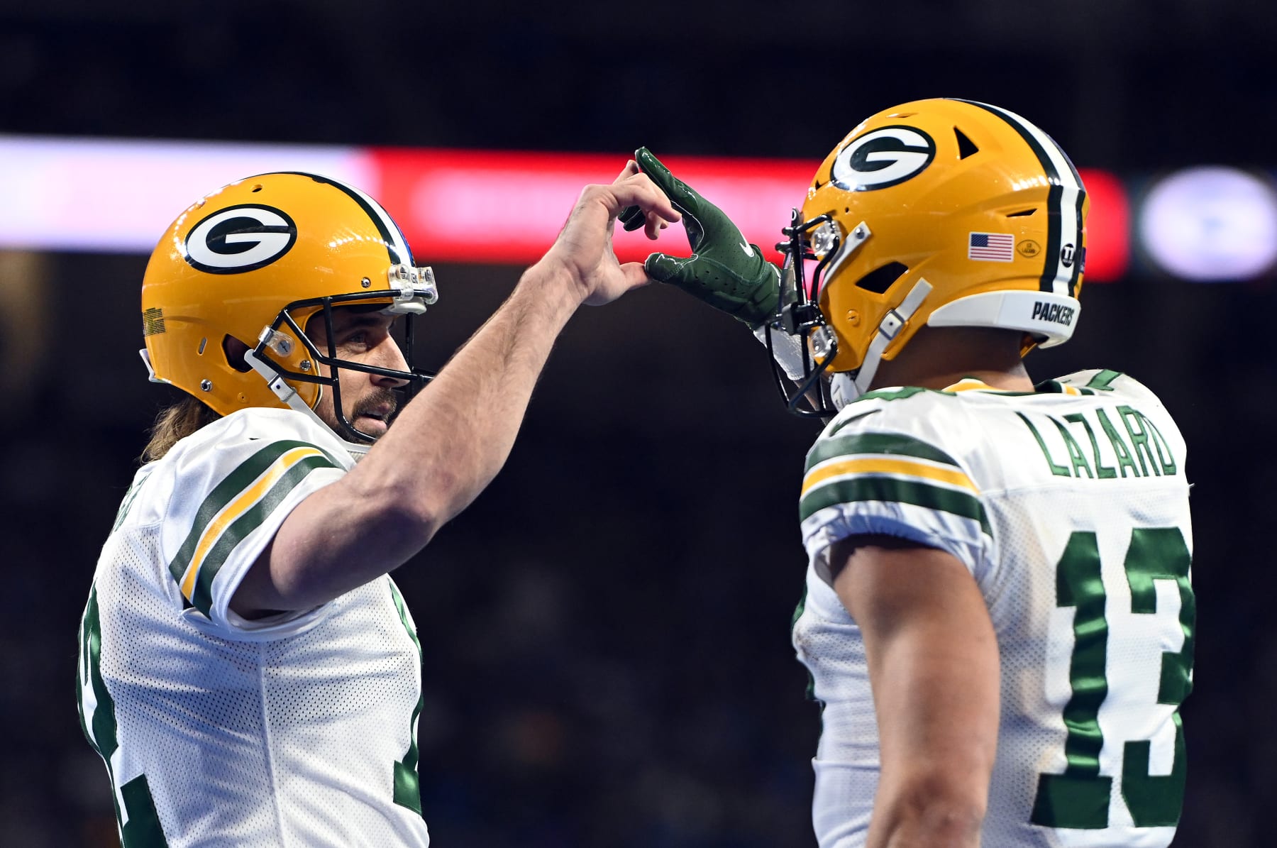 DETROIT, MICHIGAN - JANUARY 09: Aaron Rodgers #12 of the Green Bay Packers and Allen Lazard #13 of the Green Bay Packers celebrate after a touchdown during the second quarter against the Detroit Lions at Ford Field on January 09, 2022 in Detroit, Michigan. (Photo by Nic Antaya/Getty Images)