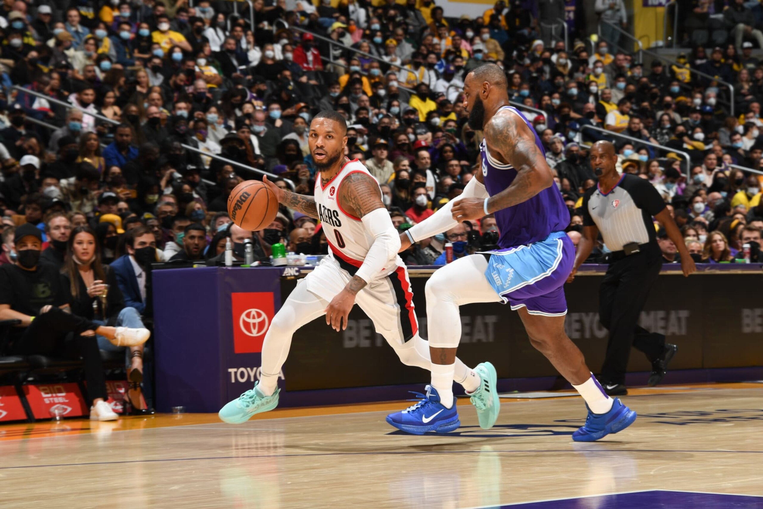 LOS ANGELES, CA - DECEMBER 31: Damian Lillard #0 of the Portland Trail Blazers handles the ball as LeBron James #6 of the Los Angeles Lakers plays defense during the game on December 31, 2021 at Crypto.Com Arena in Los Angeles, California. NOTE TO USER: User expressly acknowledges and agrees that, by downloading and/or using this Photograph, user is consenting to the terms and conditions of the Getty Images License Agreement. Mandatory Copyright Notice: Copyright 2021 NBAE (Photo by Andrew D. Bernstein/NBAE via Getty Images)
