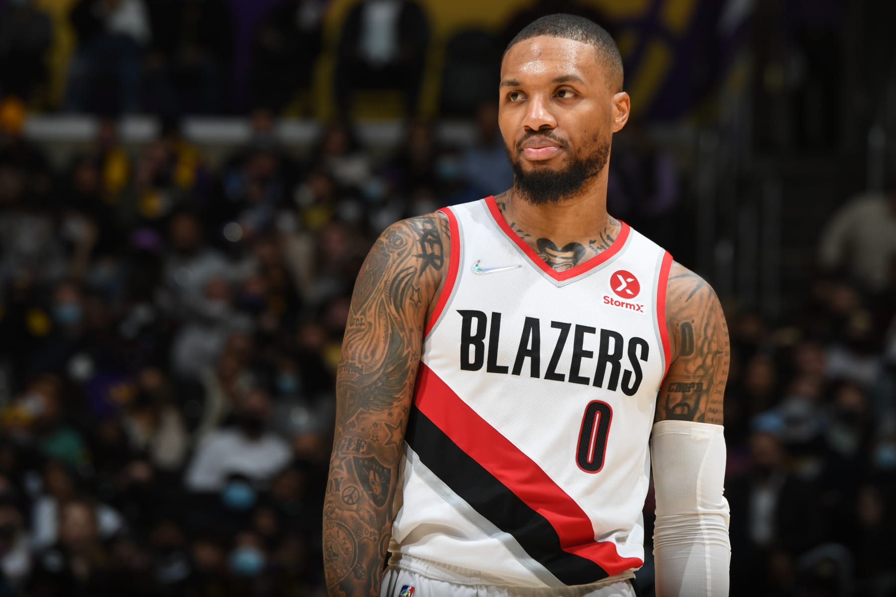 LOS ANGELES, CA - DECEMBER 31: Damian Lillard #0 of the Portland Trail Blazers looks on during the game against the Los Angeles Lakers on December 31, 2021 at Crypto.Com Arena in Los Angeles, California. NOTE TO USER: User expressly acknowledges and agrees that, by downloading and/or using this Photograph, user is consenting to the terms and conditions of the Getty Images License Agreement. Mandatory Copyright Notice: Copyright 2021 NBAE (Photo by Andrew D. Bernstein/NBAE via Getty Images)