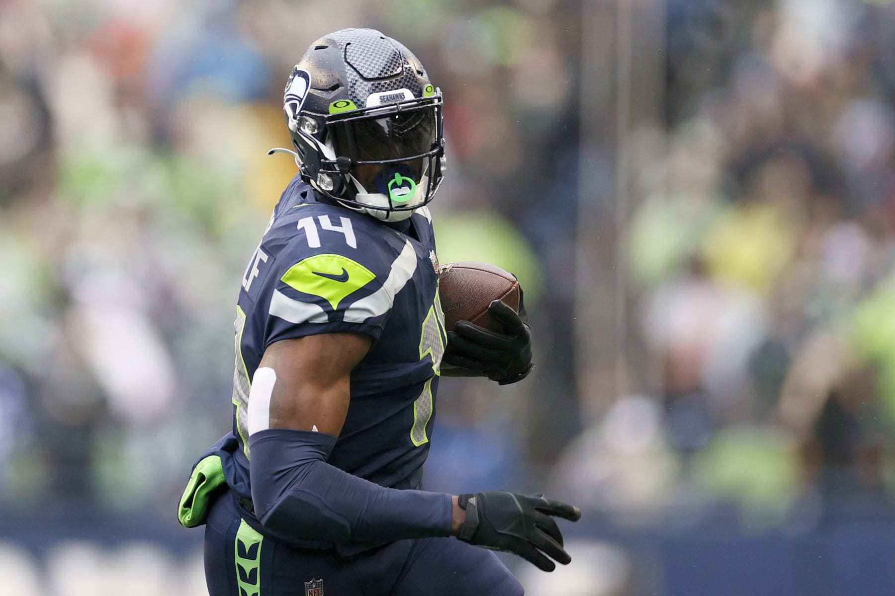 SEATTLE, WASHINGTON - JANUARY 02: DK Metcalf #14 of the Seattle Seahawks carries the ball against the Detroit Lions during the first half at Lumen Field on January 02, 2022 in Seattle, Washington. (Photo by Steph Chambers/Getty Images)
