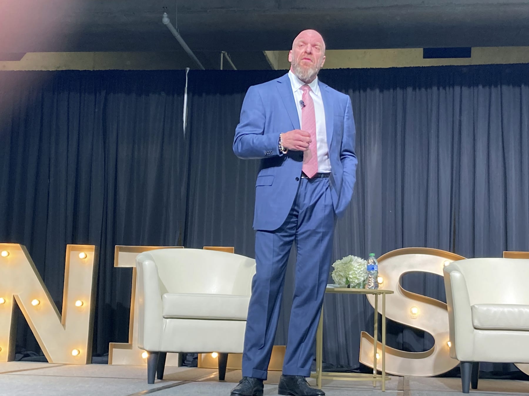 Paul Levesque, better known to wrestling fans as Triple H of the WWE, speaks at the NIL Summit held at the College Football Hall of Fame in Atlanta, on Tuesday, June 14, 2022. (AP Photo/Ralph Russo)