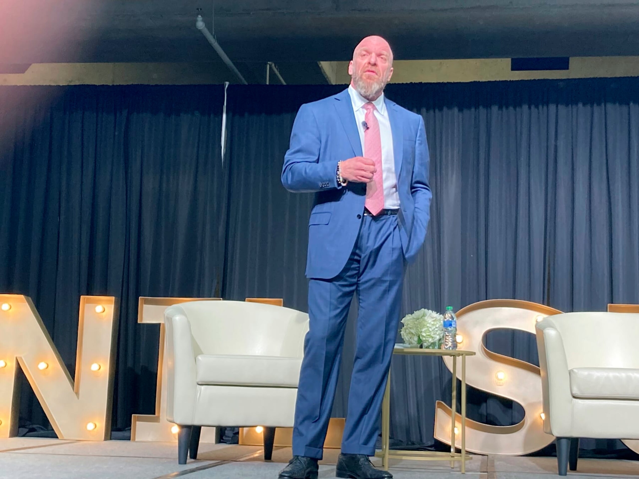 Paul Levesque, better known to wrestling fans as Triple H of the WWE, speaks at the NIL Summit held at the College Football Hall of Fame in Atlanta, on Tuesday, June 14, 2022. (AP Photo/Ralph Russo)