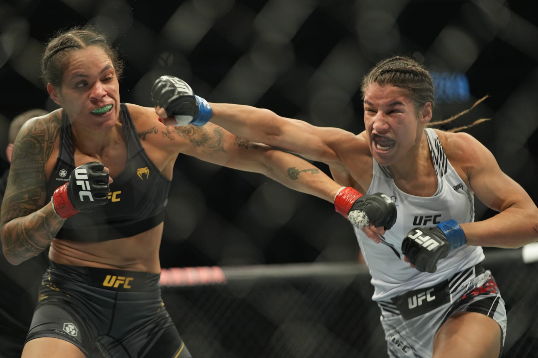 LAS VEGAS, NV - DECEMBER 11: (R-L) Julianna Peña punches Amanda Nunes in their womans bantamweight title fight during the UFC 269 on December 11, 2021, at T-Mobile Arena in Las Vegas, NV. (Photo by Louis Grasse/PxImages/Icon Sportswire via Getty Images)
