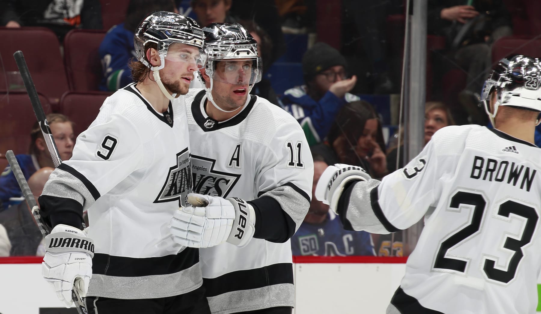 VANCOUVER, BC - APRIL 28: Adrian Kempe #9 of the Los Angeles Kings is congratulated by teammates Dustin Brown #23 and Anze Kopitar #11 after scoring during their NHL game against the Vancouver Canucks at Rogers Arena April 28, 2022 in Vancouver, British Columbia, Canada.  (Photo by Jeff Vinnick/NHLI via Getty Images)