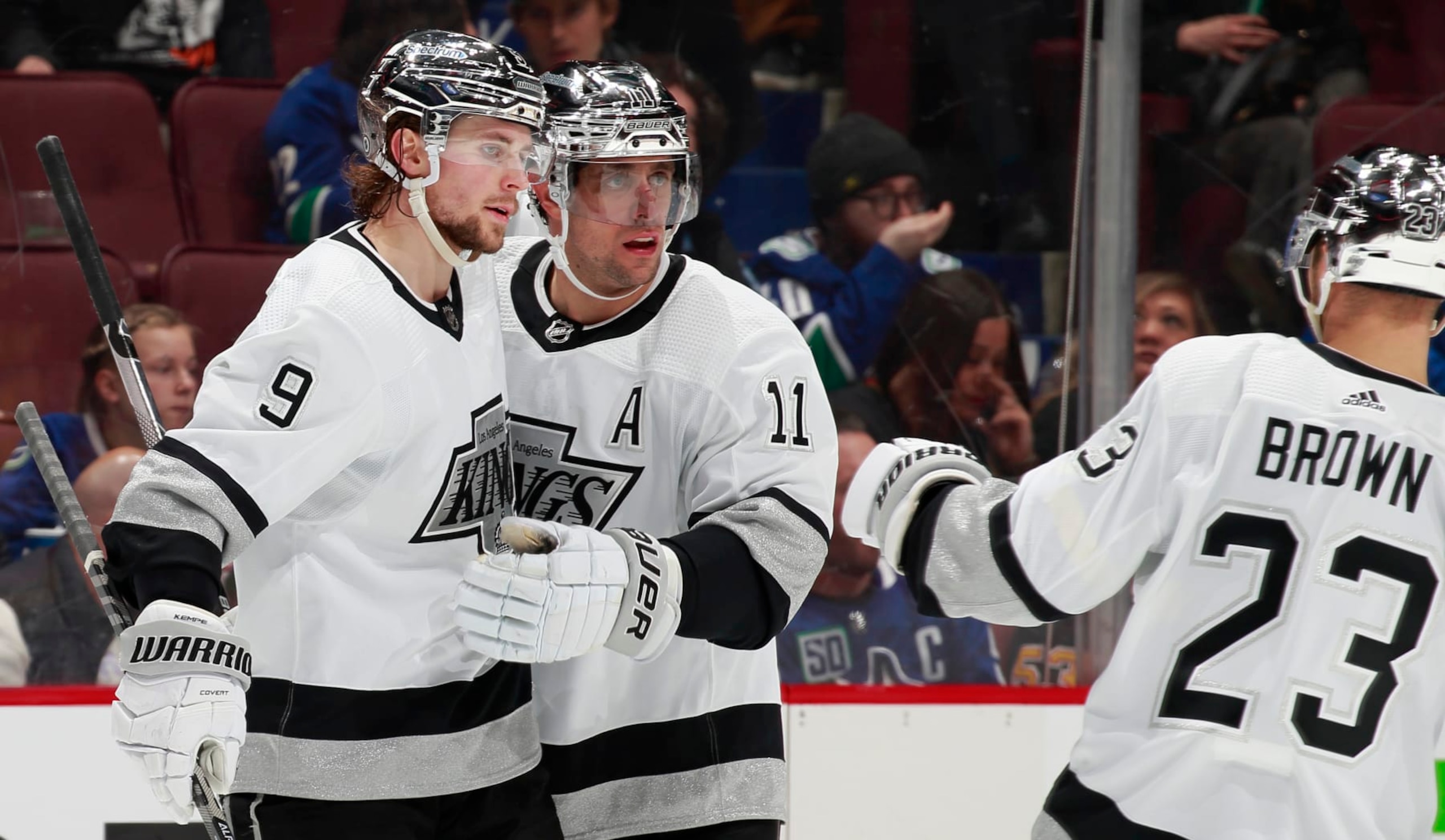 VANCOUVER, BC - APRIL 28: Adrian Kempe #9 of the Los Angeles Kings is congratulated by teammates Dustin Brown #23 and Anze Kopitar #11 after scoring during their NHL game against the Vancouver Canucks at Rogers Arena April 28, 2022 in Vancouver, British Columbia, Canada. (Photo by Jeff Vinnick/NHLI via Getty Images) VANCOUVER, BC - APRIL 28: Adrian Kempe #9 of the Los Angeles Kings is congratulated by teammates Dustin Brown #23 and Anze Kopitar #11 after scoring during their NHL game against the Vancouver Canucks at Rogers Arena April 28, 2022 in Vancouver, British Columbia, Canada. (Photo by Jeff Vinnick/NHLI via Getty Images)