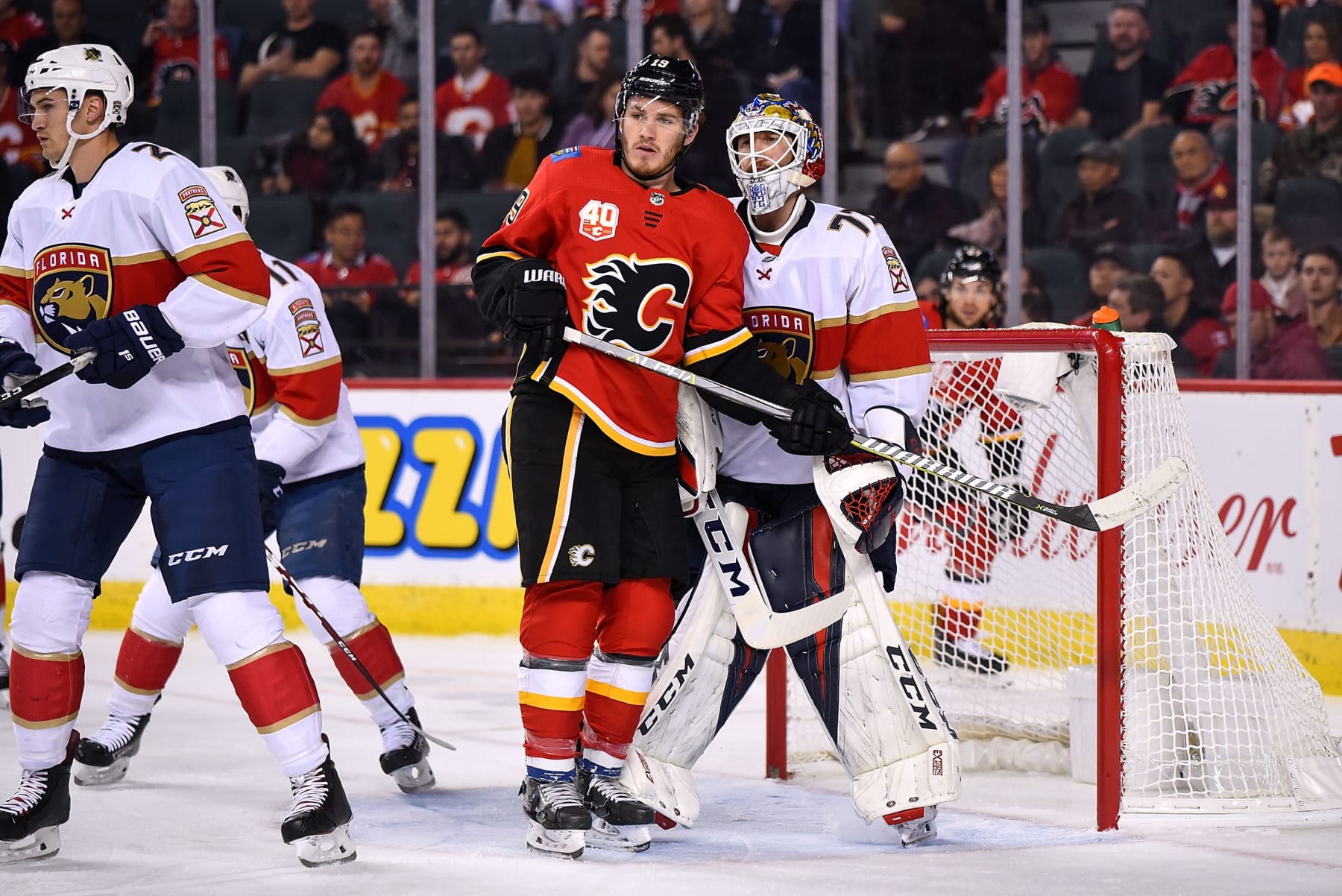 CALGARY, AB - OCTOBER 24: Calgary Flames Left Wing Matthew Tkachuk (19) bumps into Florida Panthers Goalie Sergei Bobrovsky (72) during the first period of an NHL game where the Calgary Flames hosted the Florida Panthers on October 24, 2019, at the Scotiabank Saddledome in Calgary, AB. (Photo by Brett Holmes/Icon Sportswire via Getty Images)