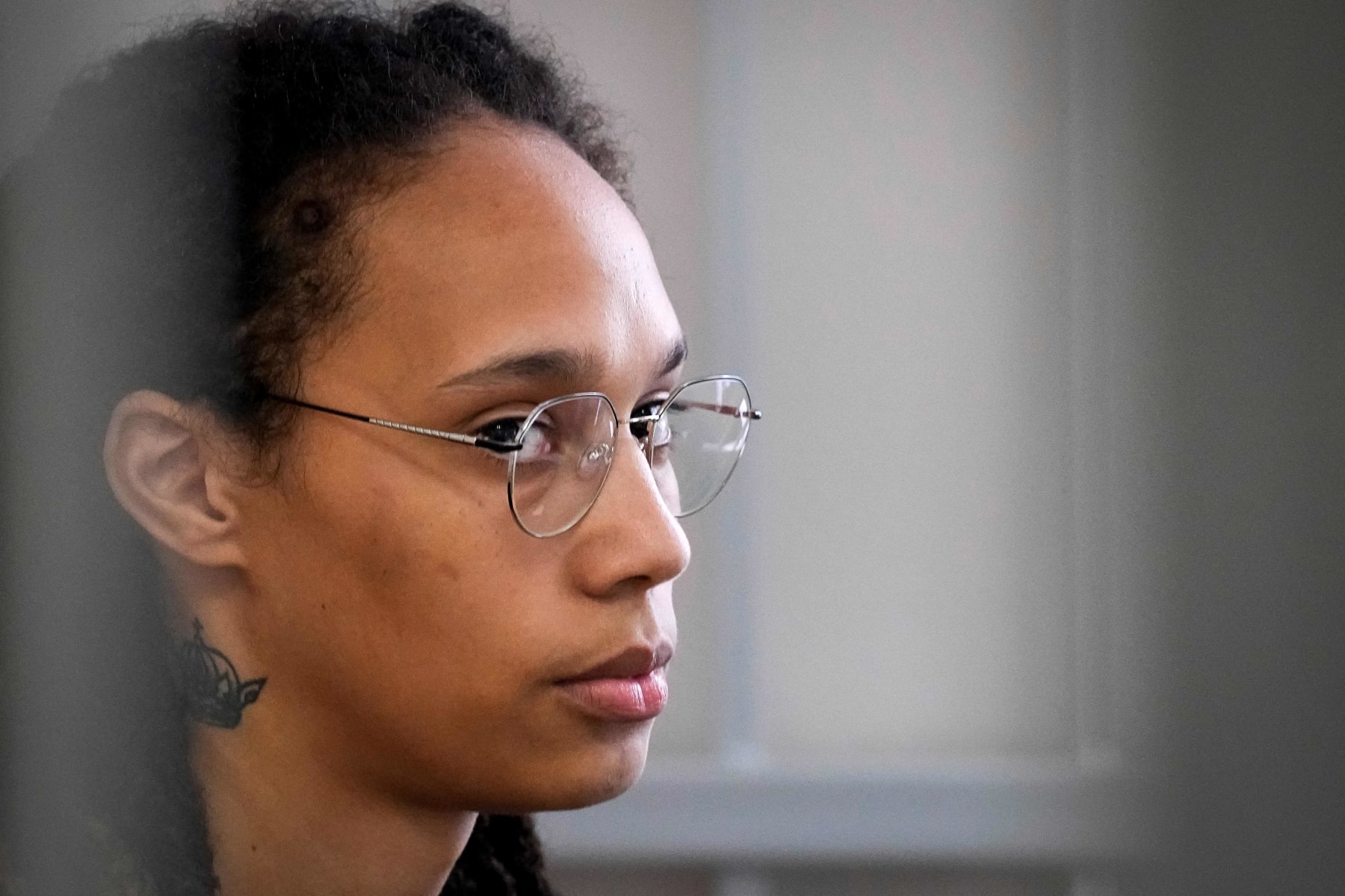 US WNBA basketball superstar Brittney Griner sits inside a defendants' cage before a hearing at the Khimki Court, outside Moscow on July 27, 2022. - Griner, a two-time Olympic gold medallist and WNBA champion, was detained at Moscow airport in February on charges of carrying in her luggage vape cartridges with cannabis oil, which could carry a 10-year prison sentence. (Photo by Alexander Zemlianichenko / POOL / AFP) (Photo by ALEXANDER ZEMLIANICHENKO/POOL/AFP via Getty Images)