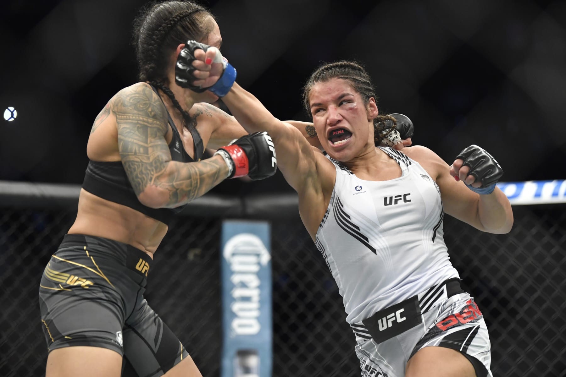 LAS VEGAS, NEVADA - DECEMBER 11: (R-L) Julianna Pena punches Amanda Nunes of Brazil in their women's bantamweight championship bout during UFC 269 at T-Mobile Arena on December 11, 2021 in Las Vegas, Nevada.  (Photo by Chris Unger/Zuffa LLC)
