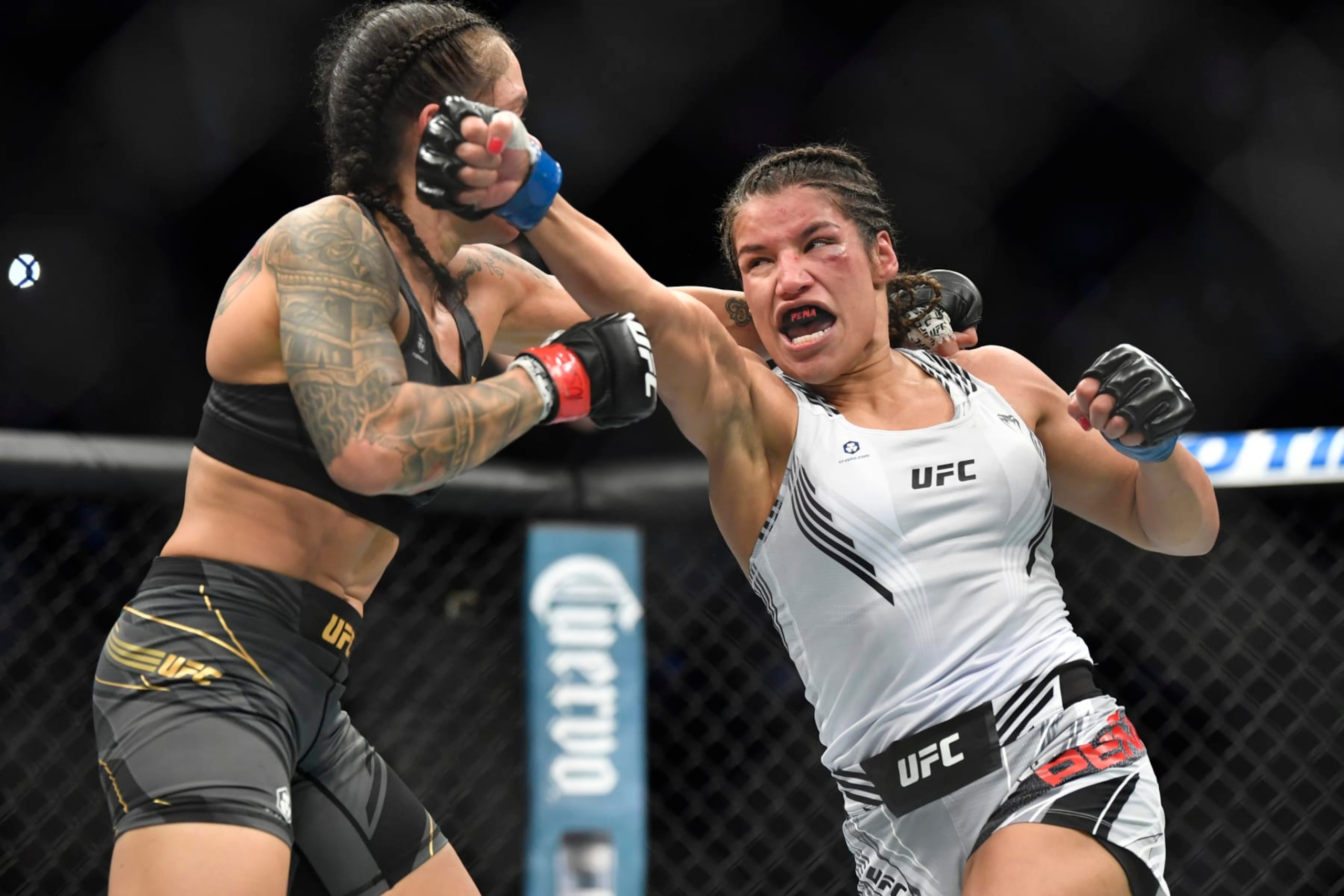LAS VEGAS, NEVADA - DECEMBER 11: (R-L) Julianna Pena punches Amanda Nunes of Brazil in their women's bantamweight championship bout during UFC 269 at T-Mobile Arena on December 11, 2021 in Las Vegas, Nevada.  (Photo by Chris Unger/Zuffa LLC)