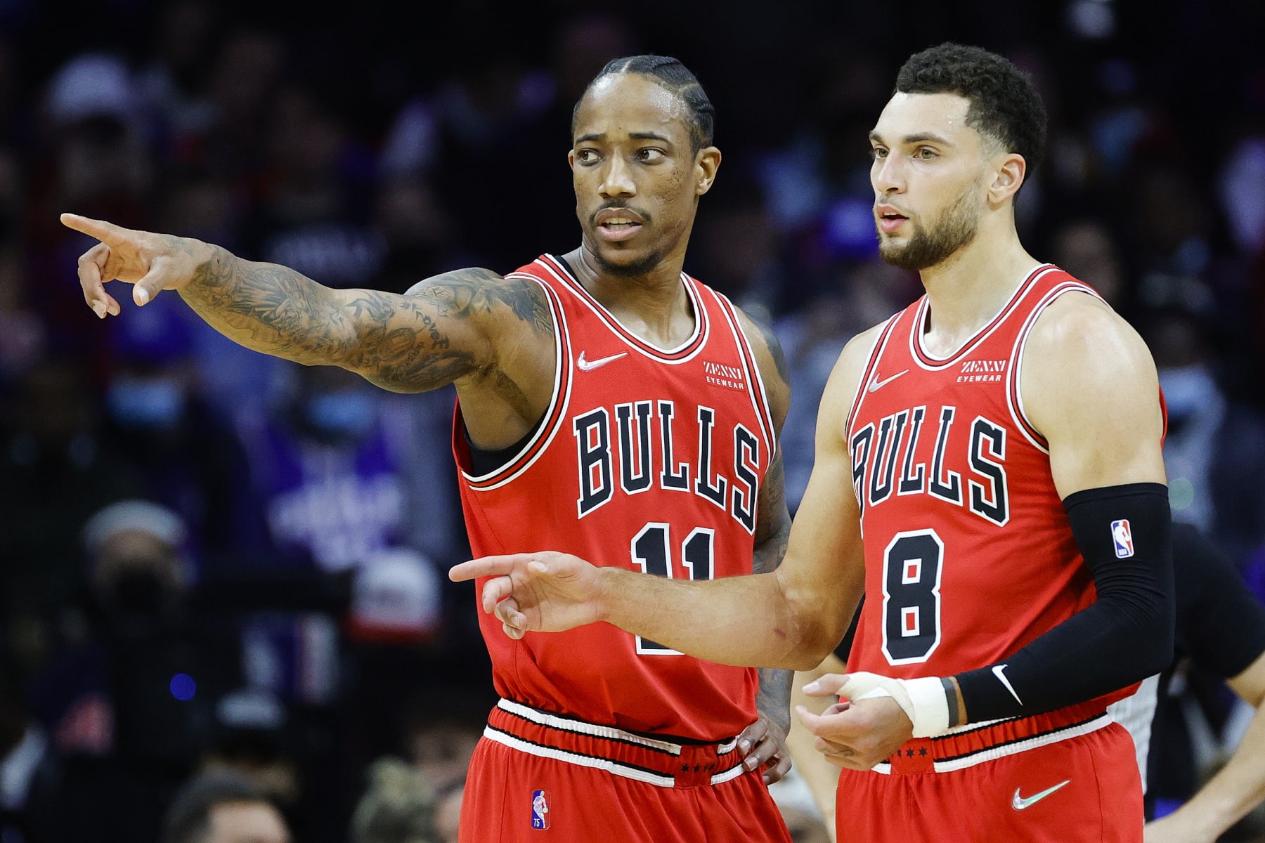PHILADELPHIA, PENNSYLVANIA - NOVEMBER 03: DeMar DeRozan #11 and Zach LaVine #8 of the Chicago Bulls speak during the first quarter against the Philadelphia 76ers at Wells Fargo Center on November 03, 2021 in Philadelphia, Pennsylvania. NOTE TO USER: User expressly acknowledges and agrees that, by downloading and/or using this photograph, user is consenting to the terms and conditions of the Getty Images License Agreement. (Photo by Tim Nwachukwu/Getty Images)