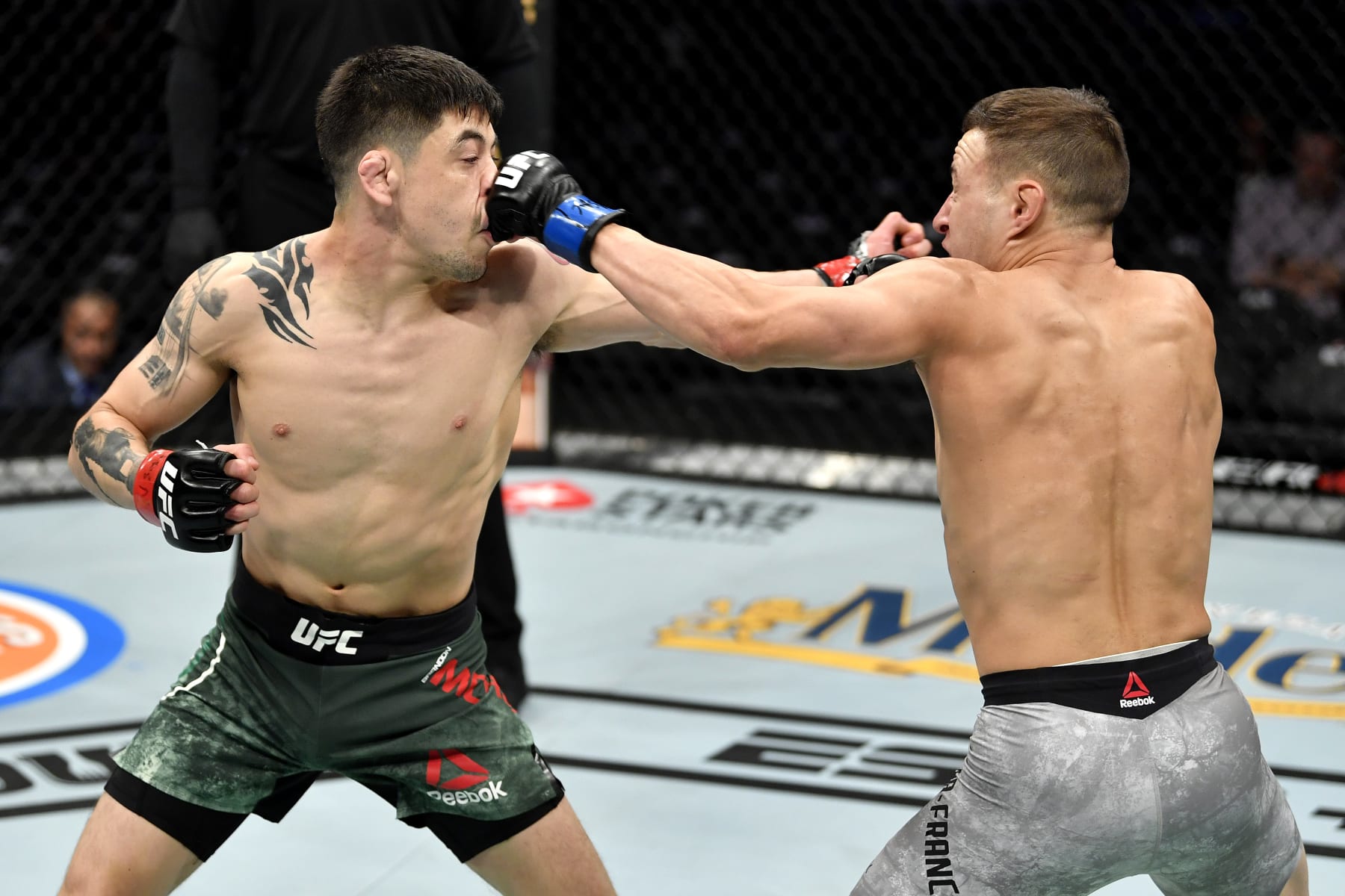LAS VEGAS, NEVADA - DECEMBER 14:  (L-R) Brandon Moreno of Mexico and Kai Kara-France of New Zealand trade blows in their flyweight bout during the UFC 245 event at T-Mobile Arena on December 14, 2019 in Las Vegas, Nevada. (Photo by Jeff Bottari/Zuffa LLC)