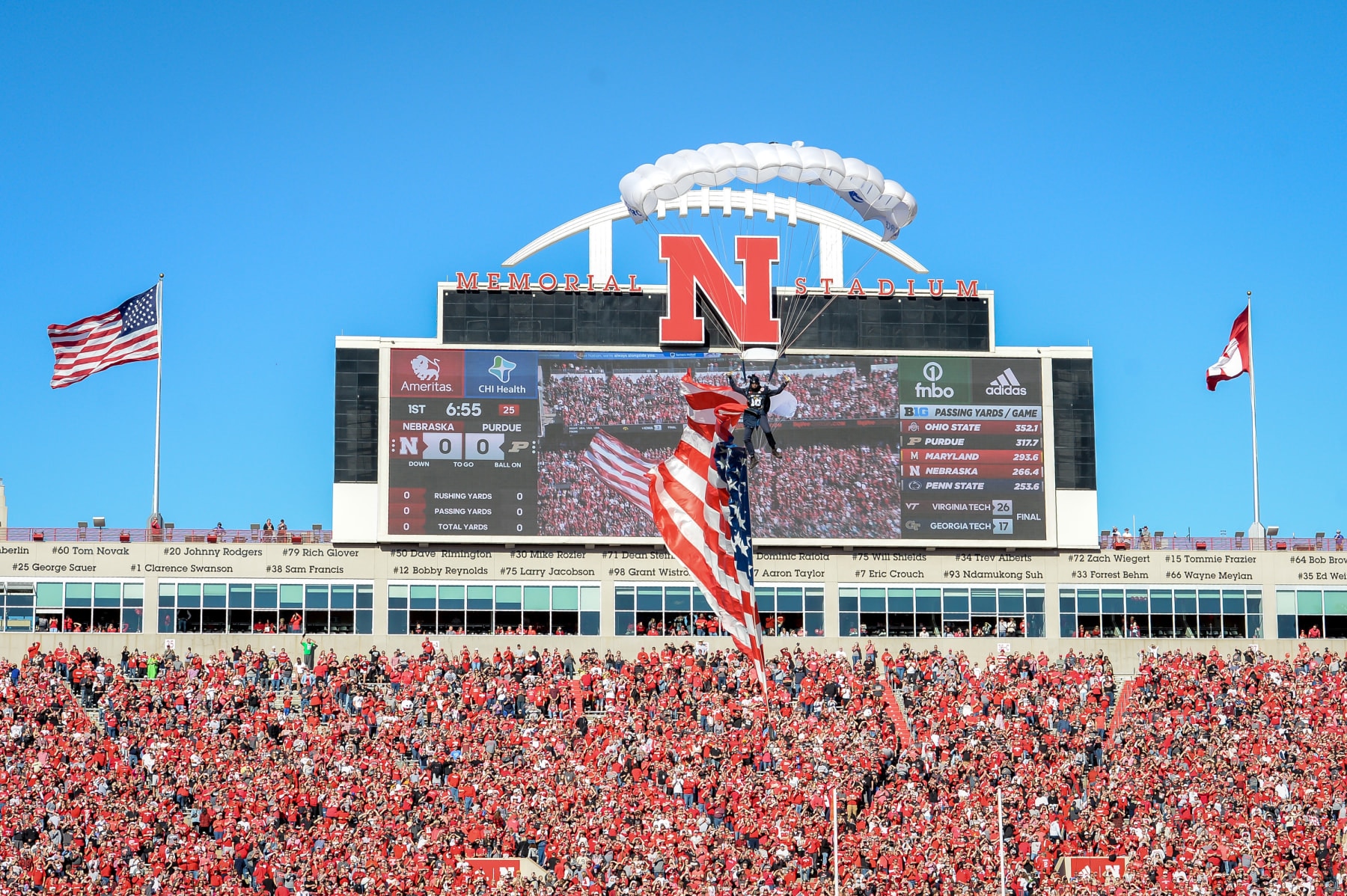 LINCOLN, NE - OCTOBER 30: Parachuters drop onto the field before the game between the Nebraska Cornhuskers and the Purdue Boilermakers at Memorial Stadium on October 30, 2021 in Lincoln, Nebraska. (Photo by Steven Branscombe/Getty Images)