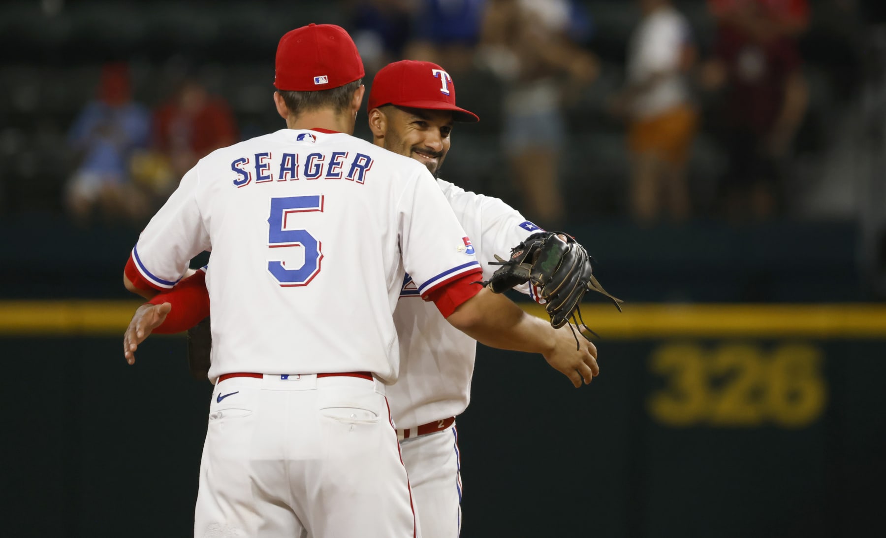 ARLINGTON, TX - JUNE 21: Corey Seager #5 of the Texas Rangers and teammate Marcus Semien #2 celebrate the team 7-0 win over the Philadelphia Phillies at Globe Life Field on June 21, 2022 in Arlington, Texas. (Photo by Ron Jenkins/Getty Images)