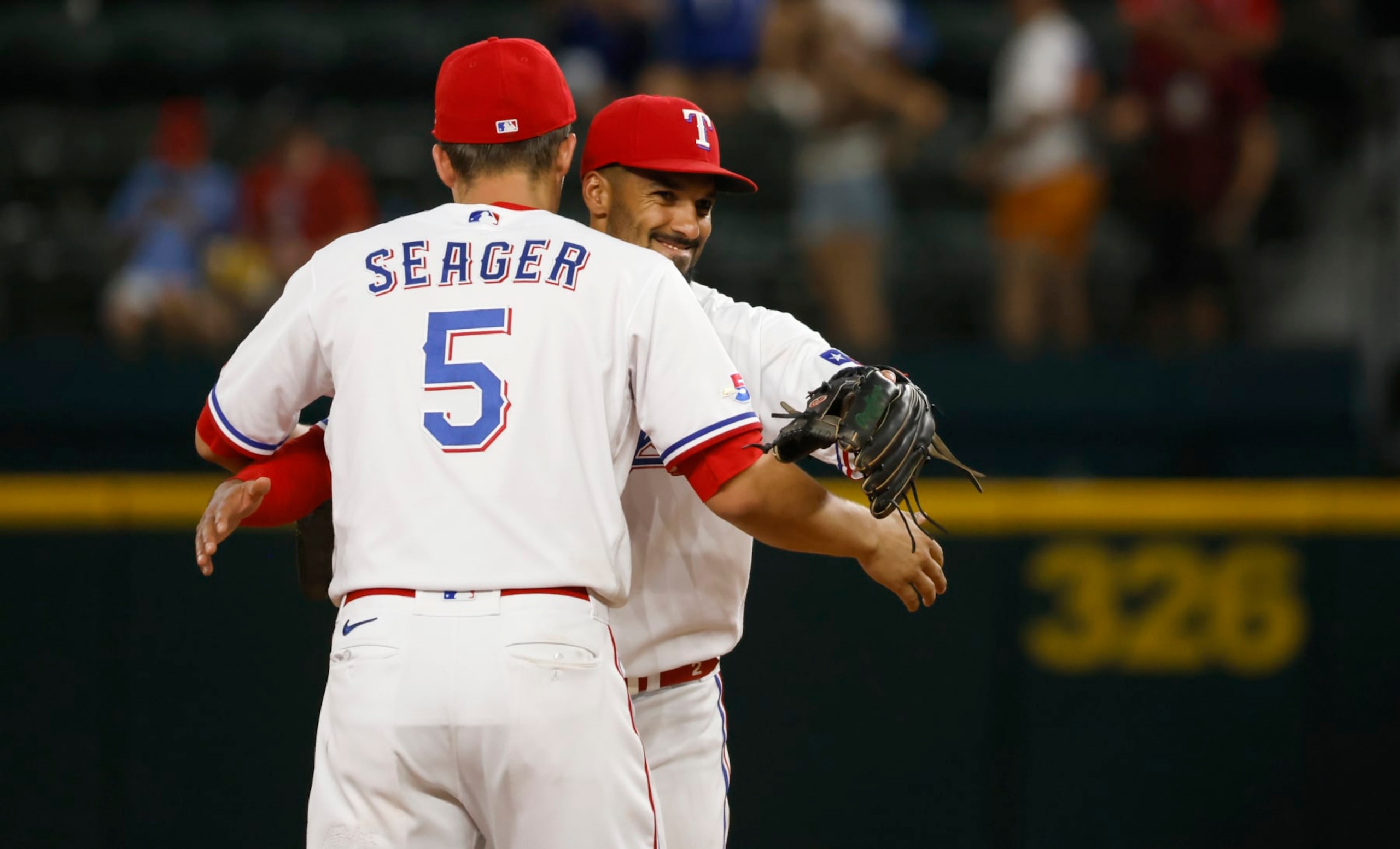 ARLINGTON, TX - JUNE 21: Corey Seager #5 of the Texas Rangers and teammate Marcus Semien #2 celebrate the team 7-0 win over the Philadelphia Phillies at Globe Life Field on June 21, 2022 in Arlington, Texas. (Photo by Ron Jenkins/Getty Images)