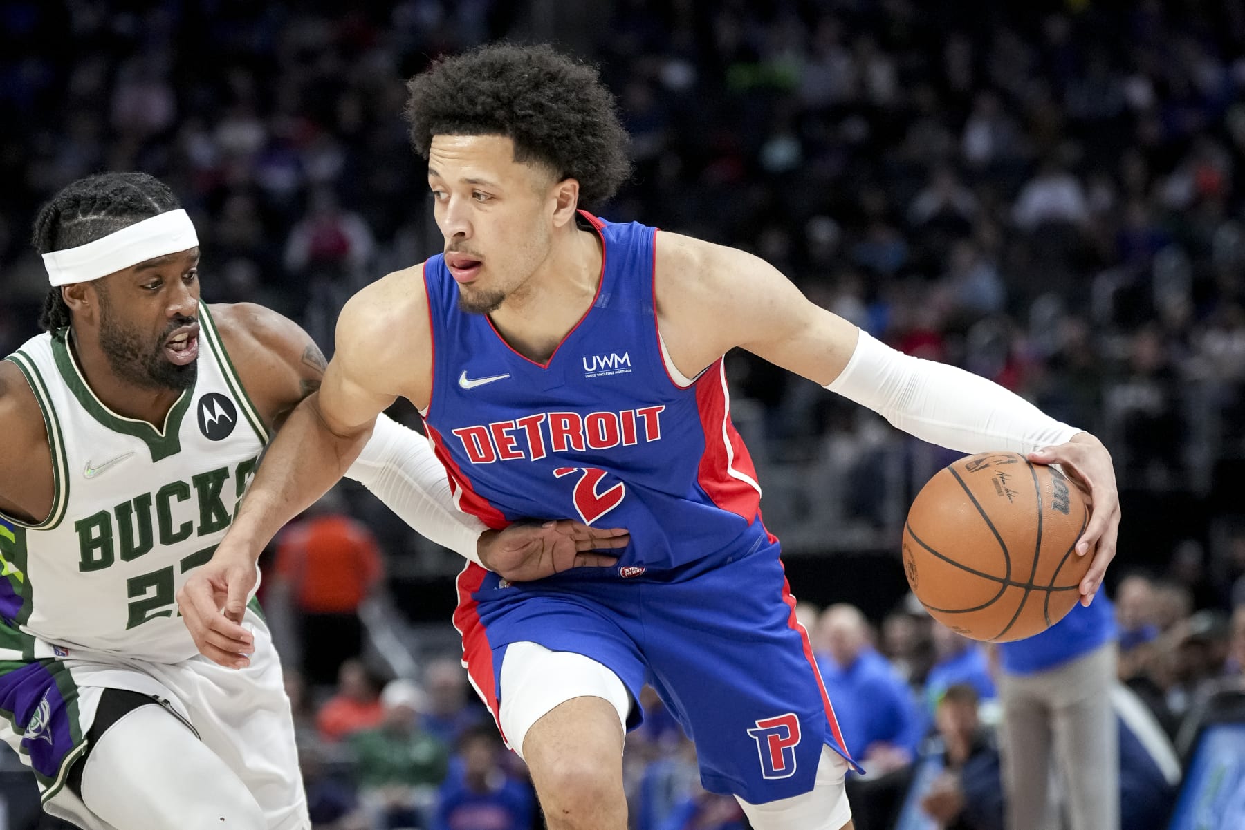 DETROIT, MICHIGAN - APRIL 08: Cade Cunningham #2 of the Detroit Pistons handles the ball against Wesley Matthews #23 of the Milwaukee Bucks during the first quarter at Little Caesars Arena on April 08, 2022 in Detroit, Michigan. NOTE TO USER: User expressly acknowledges and agrees that, by downloading and or using this photograph, User is consenting to the terms and conditions of the Getty Images License Agreement. (Photo by Nic Antaya/Getty Images)