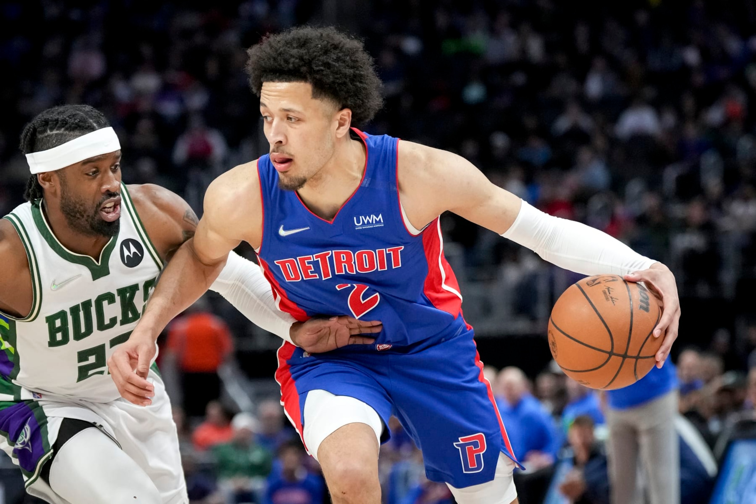DETROIT, MICHIGAN - APRIL 08: Cade Cunningham #2 of the Detroit Pistons handles the ball against Wesley Matthews #23 of the Milwaukee Bucks during the first quarter at Little Caesars Arena on April 08, 2022 in Detroit, Michigan. NOTE TO USER: User expressly acknowledges and agrees that, by downloading and or using this photograph, User is consenting to the terms and conditions of the Getty Images License Agreement. (Photo by Nic Antaya/Getty Images)