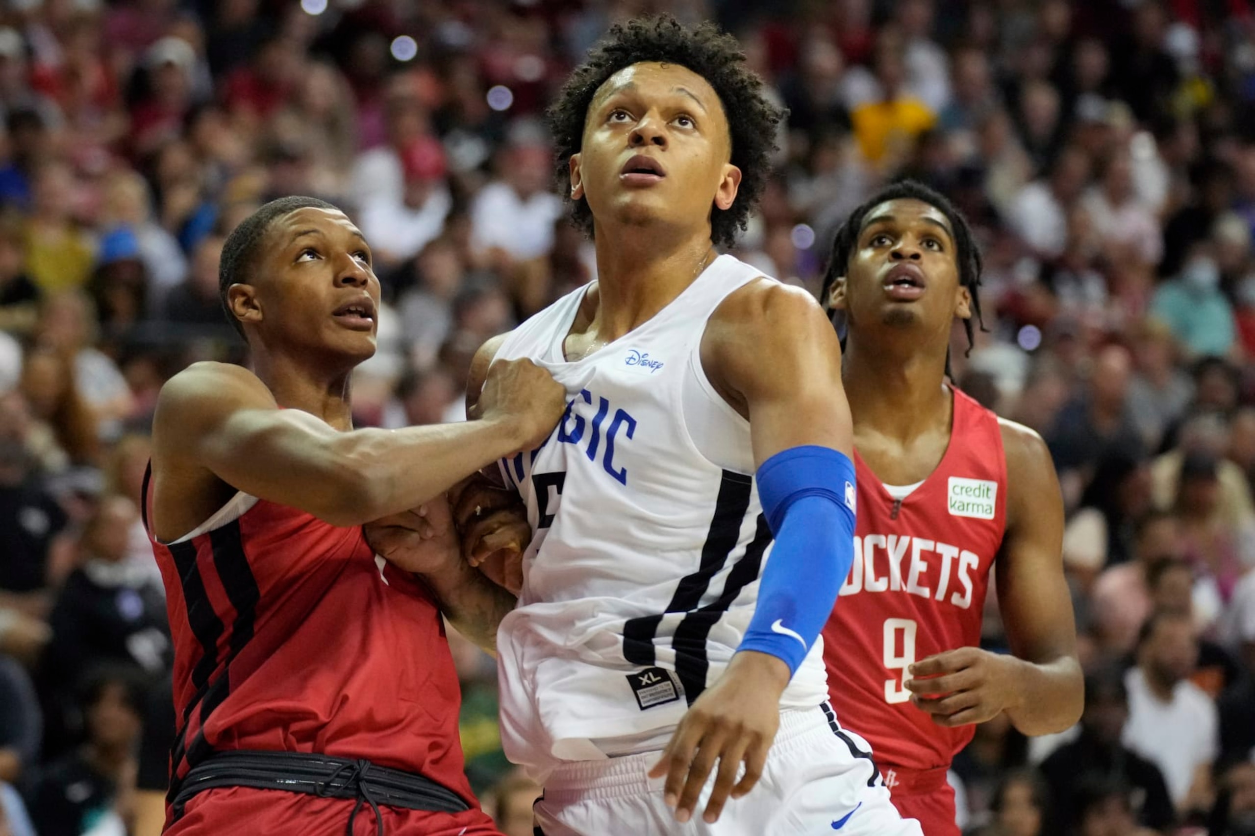 Houston Rockets' Jabari Smith Jr., left, and Orlando Magic's Paolo Banchero look for a rebound during the first half an NBA summer league basketball game Thursday, July 7, 2022, in Las Vegas. (AP Photo/John Locher)