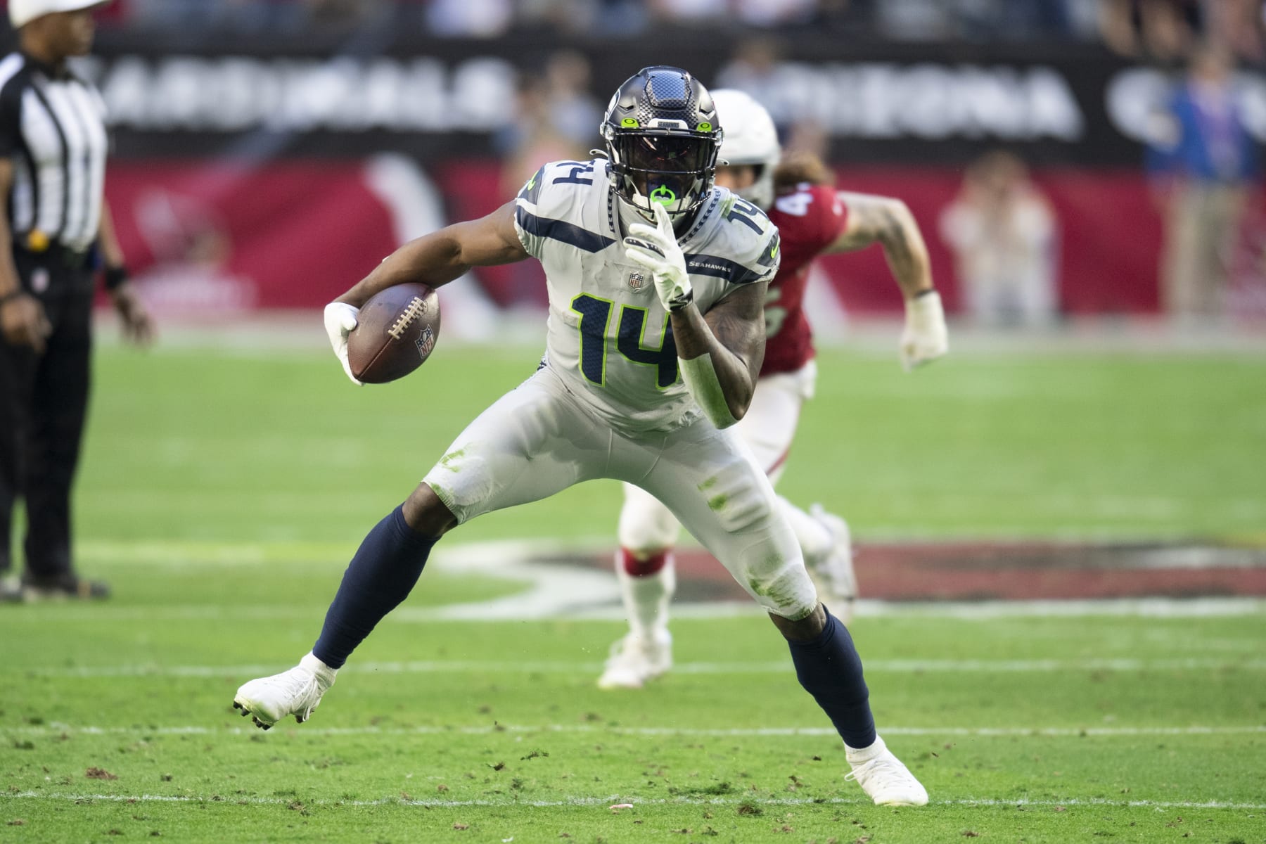 Seattle Seahawks wide receiver DK Metcalf (14) runs the ball against the Arizona Cardinals during an NFL Professional Football Game Sunday, Jan. 9, 2022, in Phoenix. (AP Photo/John McCoy)