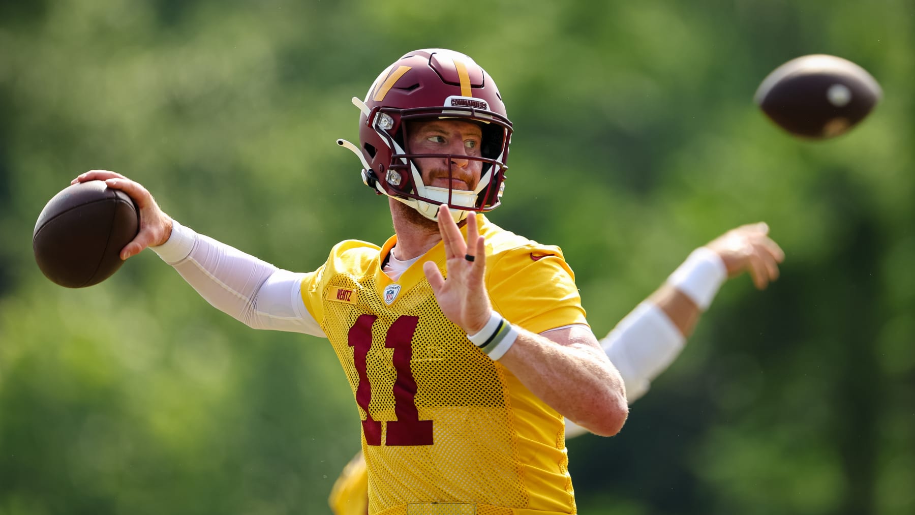 ASHBURN, VA - JUNE 16: Carson Wentz #11 of the Washington Commanders participates in a drill during the organized team activity at INOVA Sports Performance Center on June 16, 2022 in Ashburn, Virginia. (Photo by Scott Taetsch/Getty Images)