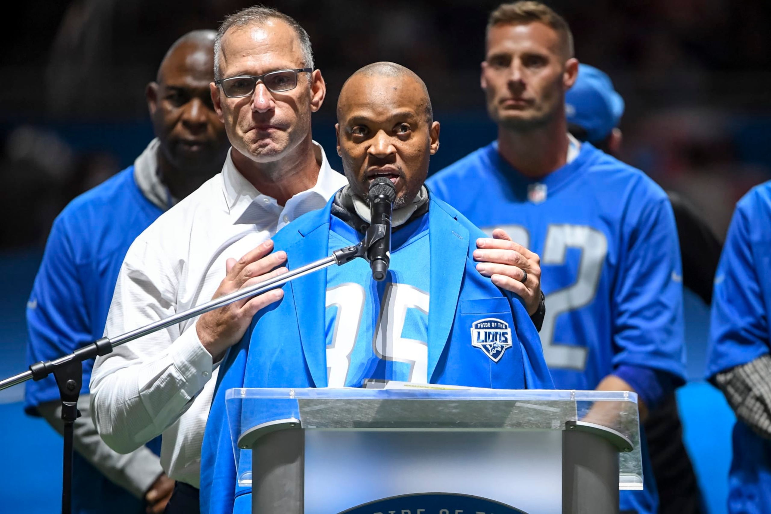 DETROIT, MICHIGAN - OCTOBER 31: Chris Spielman, left, embraces William White, both former Detroit Lions players, during the Pride of the Lions celebration during halftime in the game against the Philadelphia Eagles at Ford Field on October 31, 2021 in Detroit, Michigan. (Photo by Rey Del Rio/Getty Images)
