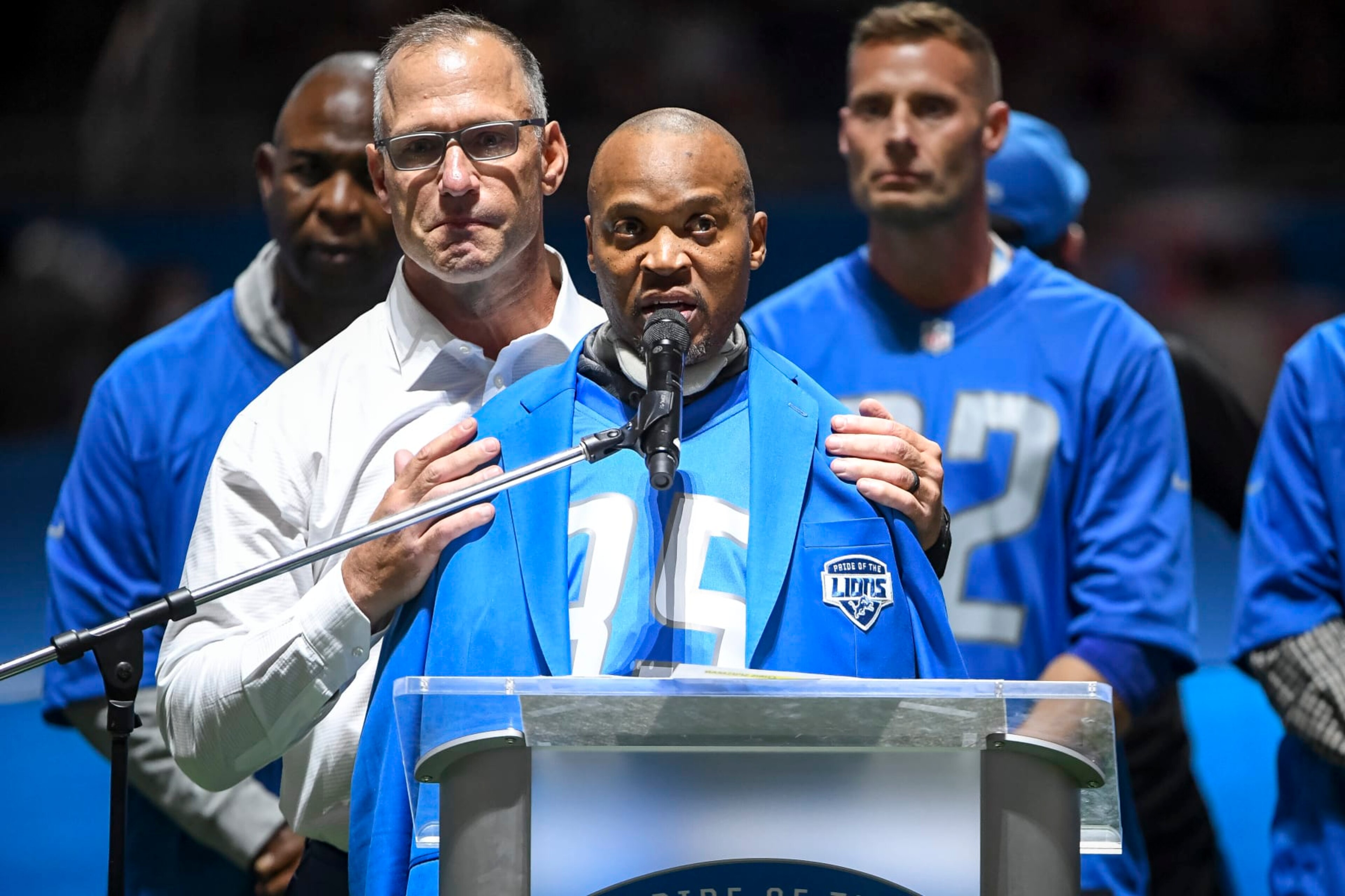 DETROIT, MICHIGAN - OCTOBER 31: Chris Spielman, left, embraces William White, both former Detroit Lions players, during the Pride of the Lions celebration during halftime in the game against the Philadelphia Eagles at Ford Field on October 31, 2021 in Detroit, Michigan. (Photo by Rey Del Rio/Getty Images)