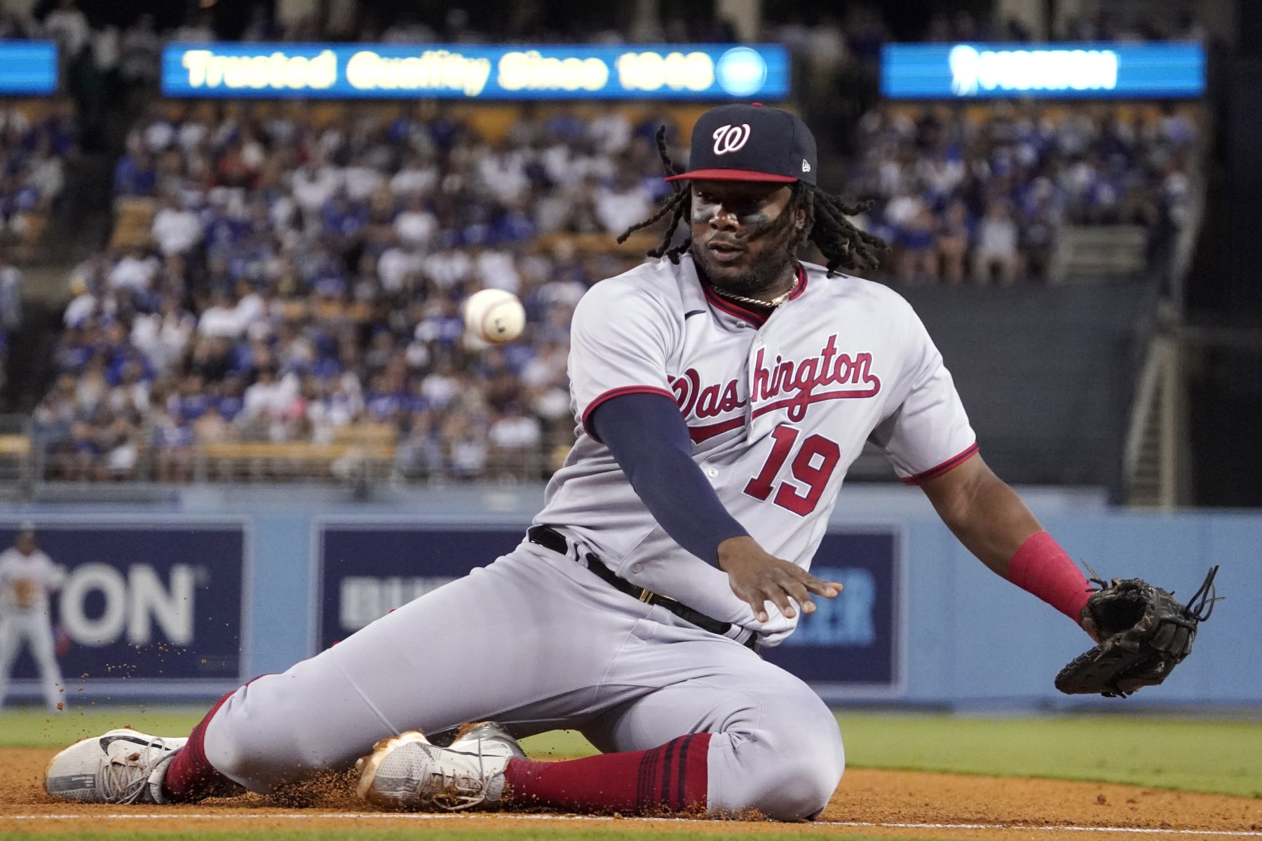 Washington Nationals first baseman Josh Bell goes after but can't get to a foul ball hit by Los Angeles Dodgers' Jake Lamb during the sixth inning of a baseball game Tuesday, July 26, 2022, in Los Angeles. (AP Photo/Mark J. Terrill)