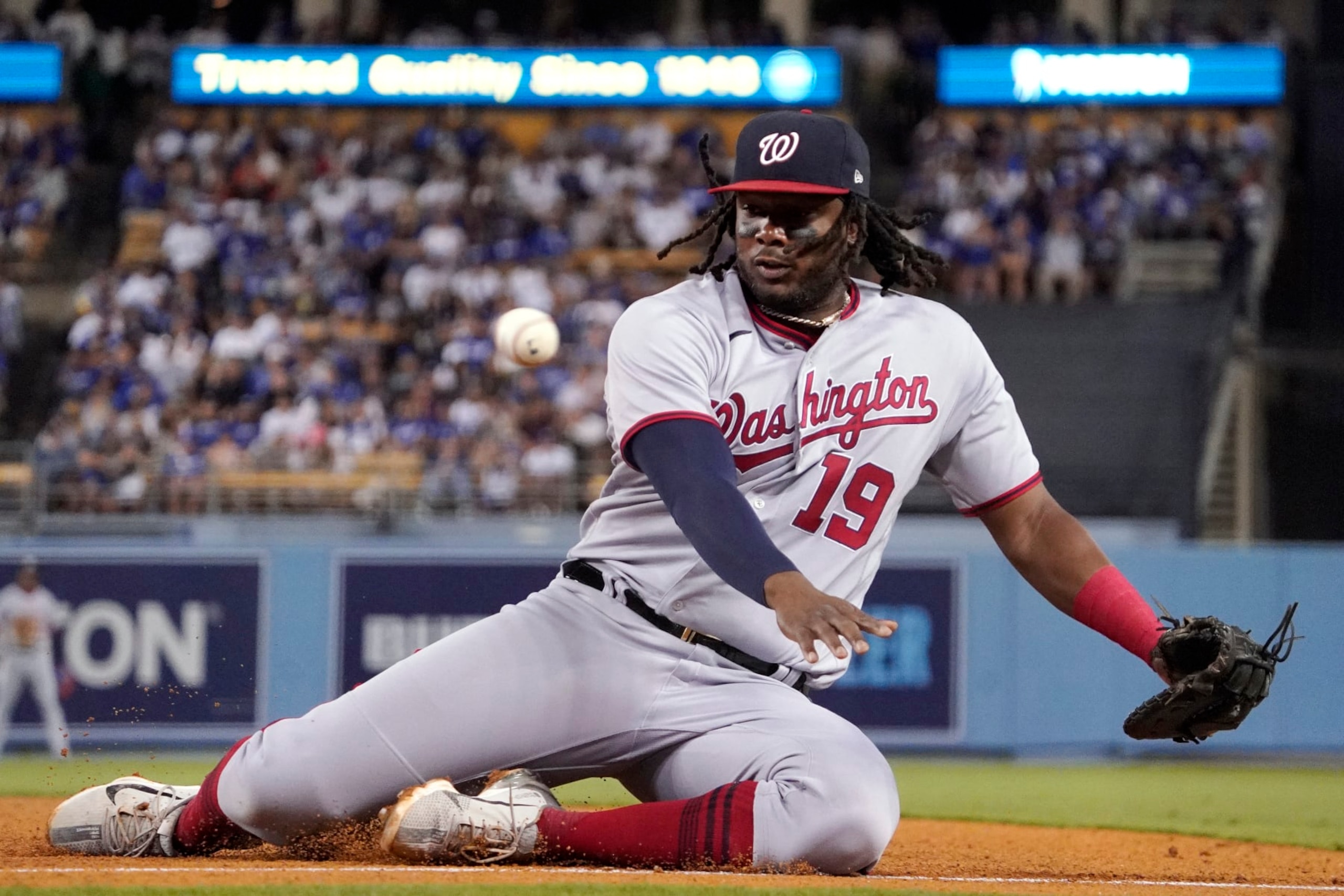 Washington Nationals first baseman Josh Bell goes after but can't get to a foul ball hit by Los Angeles Dodgers' Jake Lamb during the sixth inning of a baseball game Tuesday, July 26, 2022, in Los Angeles. (AP Photo/Mark J. Terrill)