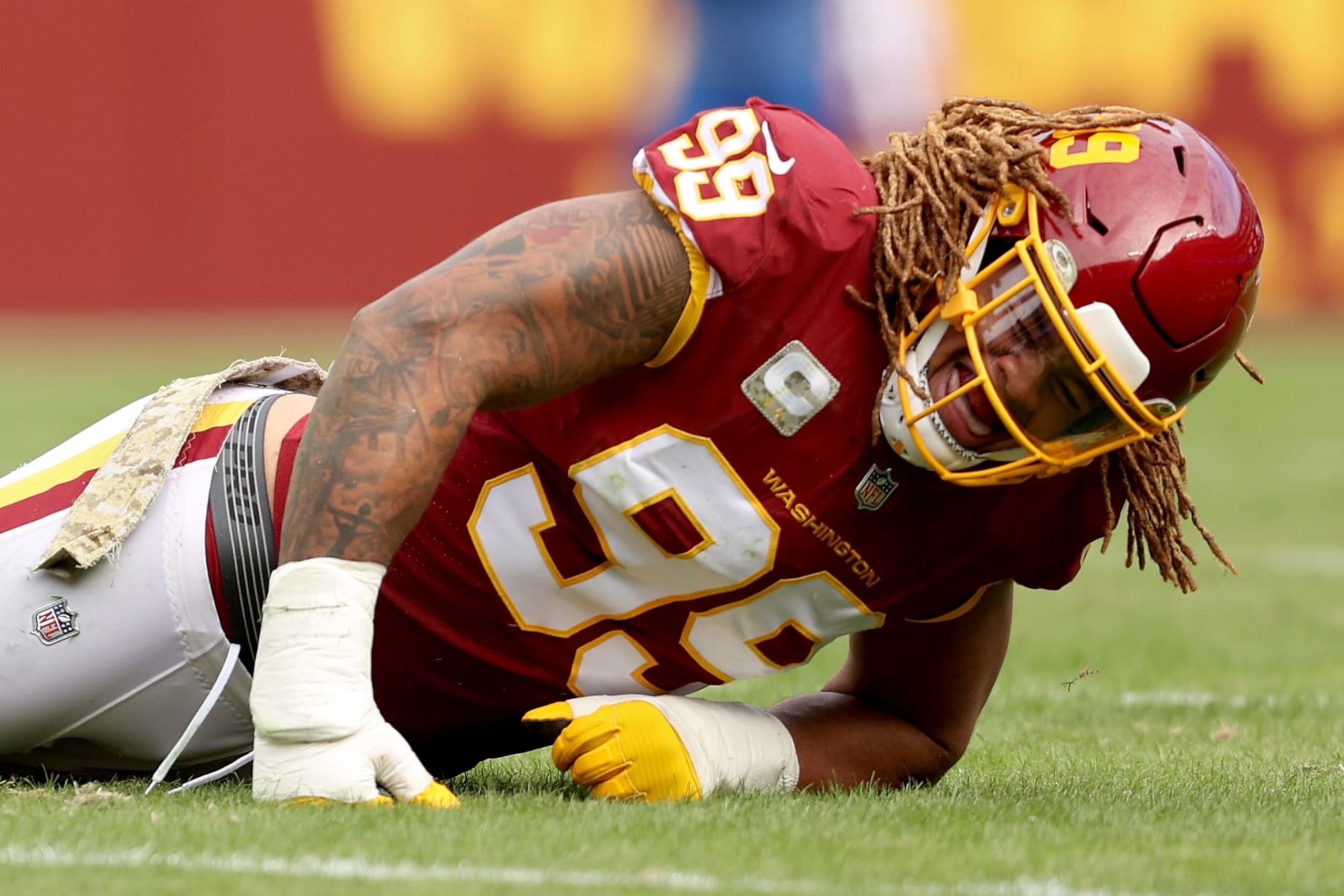 LANDOVER, MARYLAND - NOVEMBER 14: Chase Young #99 of the Washington Football Team reacts after an injury during the first half against the Tampa Bay Buccaneers at FedExField on November 14, 2021 in Landover, Maryland. (Photo by Patrick Smith/Getty Images)