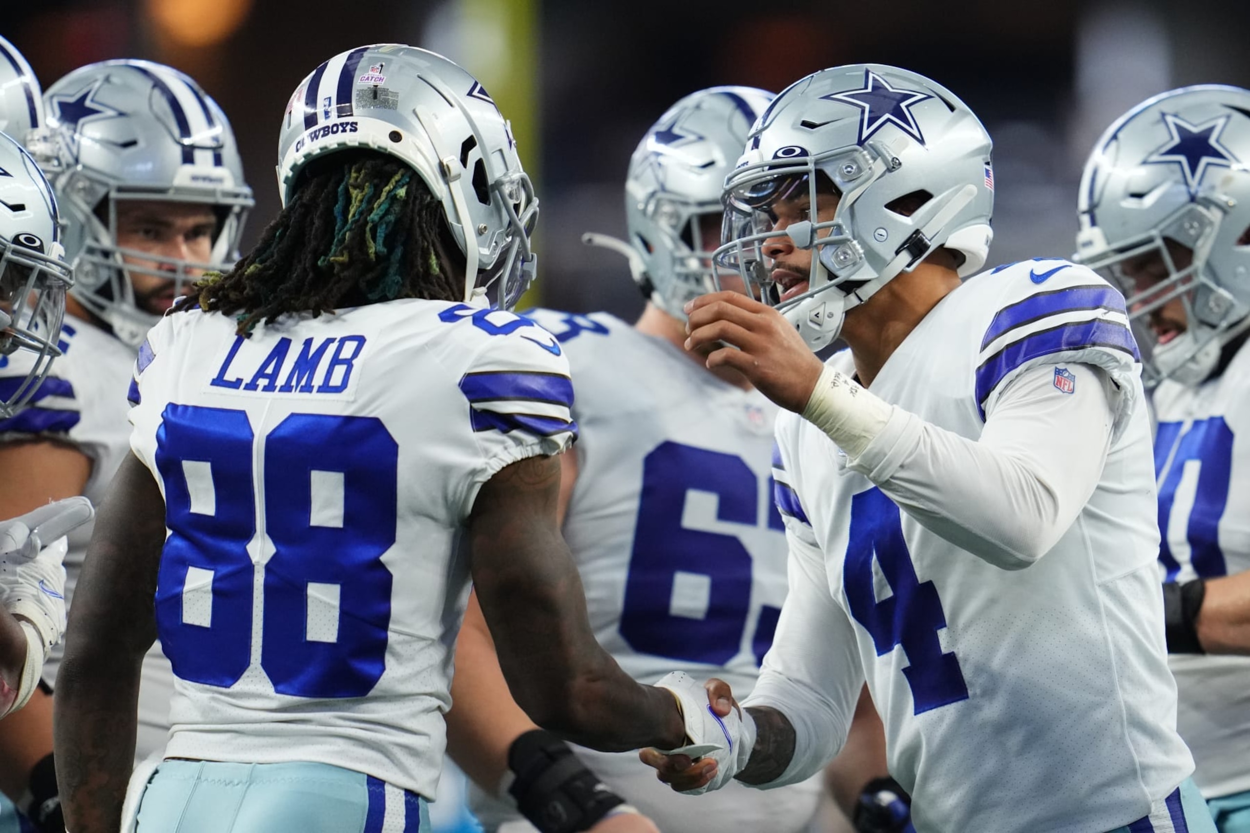 ARLINGTON, TEXAS - OCTOBER 03: Dak Prescott #4 of the Dallas Cowboys celebrates with wide receiver CeeDee Lamb (88) against the Carolina Panthers during an NFL game at AT&T Stadium on October 03, 2021 in Arlington, Texas. (Photo by Cooper Neill/Getty Images)