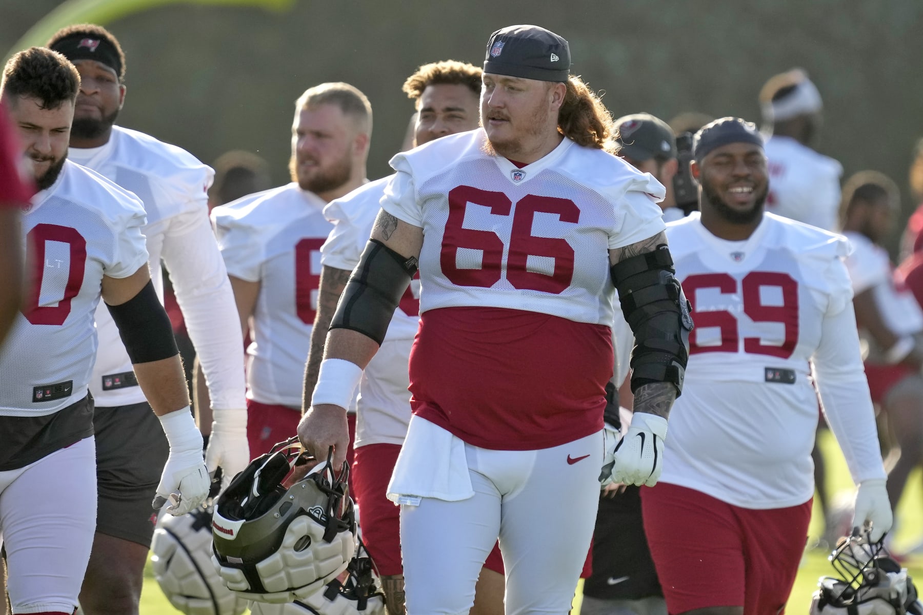 Tampa Bay Buccaneers center Ryan Jensen (66) walks with fellow offensive linemen during an NFL football training camp practice Wednesday, July 27, 2022, in Tampa, Fla. (AP Photo/Chris O'Meara) Tampa Bay Buccaneers center Ryan Jensen (66) walks with fellow offensive linemen during an NFL football training camp practice Wednesday, July 27, 2022, in Tampa, Fla. (AP Photo/Chris O'Meara)