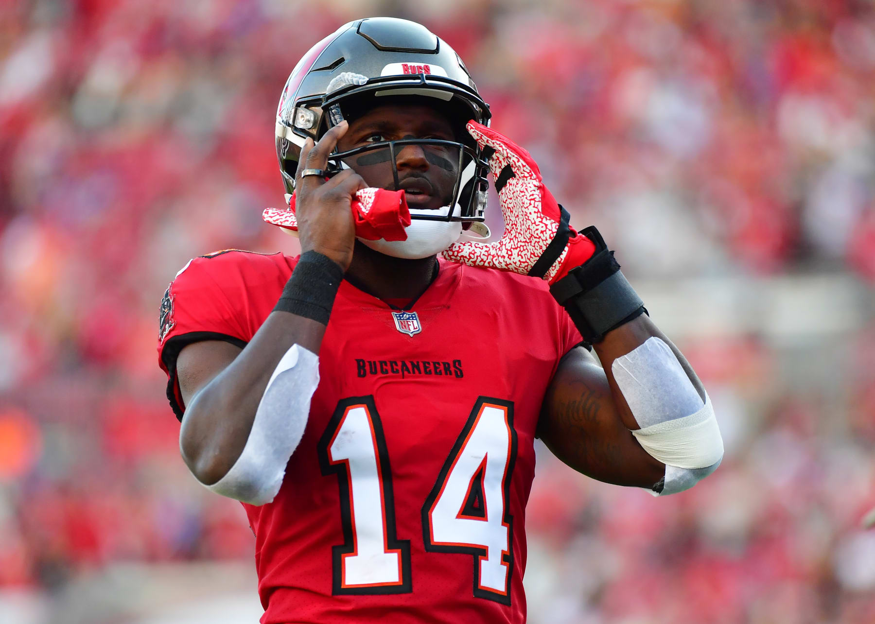 TAMPA, FLORIDA - DECEMBER 12: Chris Godwin #14 of the Tampa Bay Buccaneers adjusts his helmet prior to a game against the Buffalo Bills at Raymond James Stadium on December 12, 2021 in Tampa, Florida. (Photo by Julio Aguilar/Getty Images) TAMPA, FLORIDA - DECEMBER 12: Chris Godwin #14 of the Tampa Bay Buccaneers adjusts his helmet prior to a game against the Buffalo Bills at Raymond James Stadium on December 12, 2021 in Tampa, Florida. (Photo by Julio Aguilar/Getty Images)