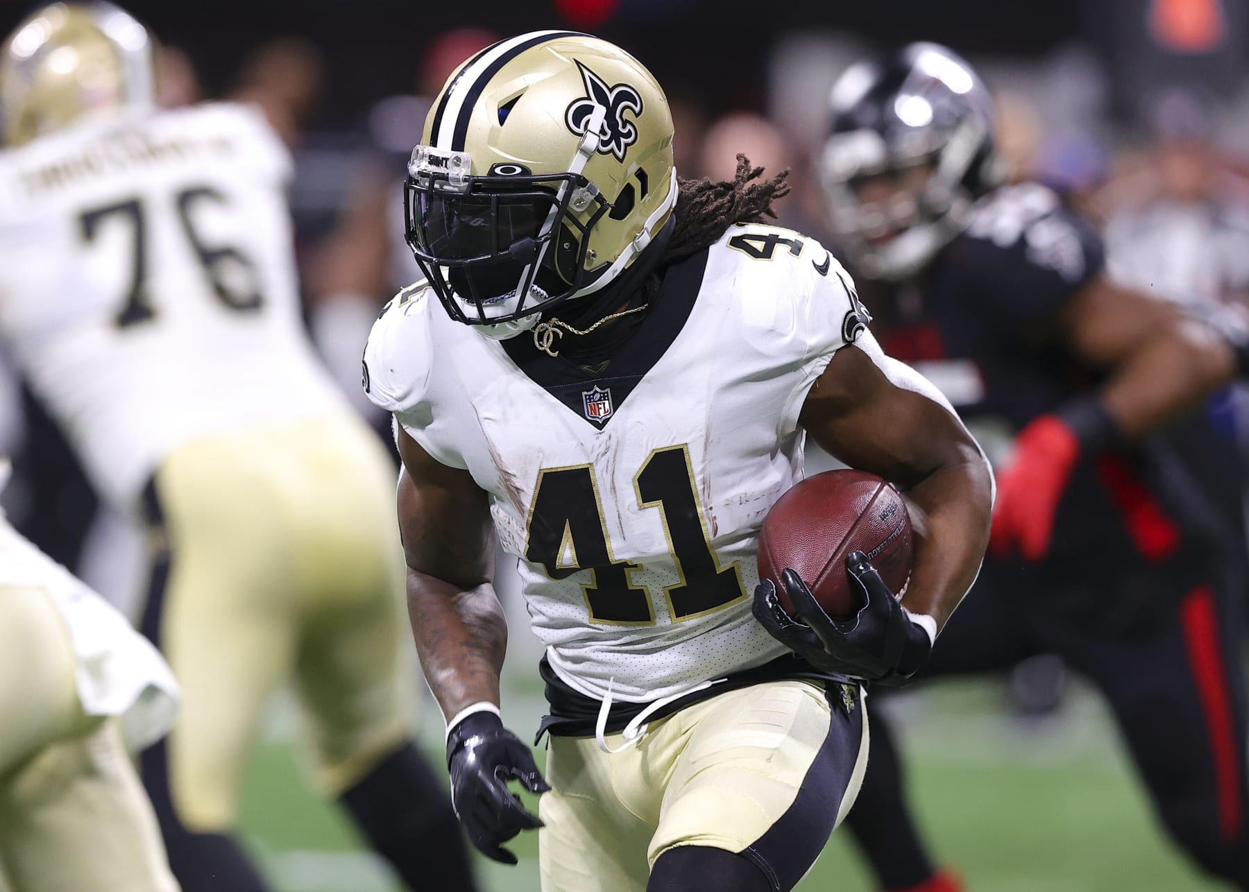 ATLANTA, GA - JANUARY 09: Alvin Kamara #41 of the New Orleans Saints rushes during the first half against the Atlanta Falcons at Mercedes-Benz Stadium on January 9, 2022 in Atlanta, Georgia. (Photo by Todd Kirkland/Getty Images)