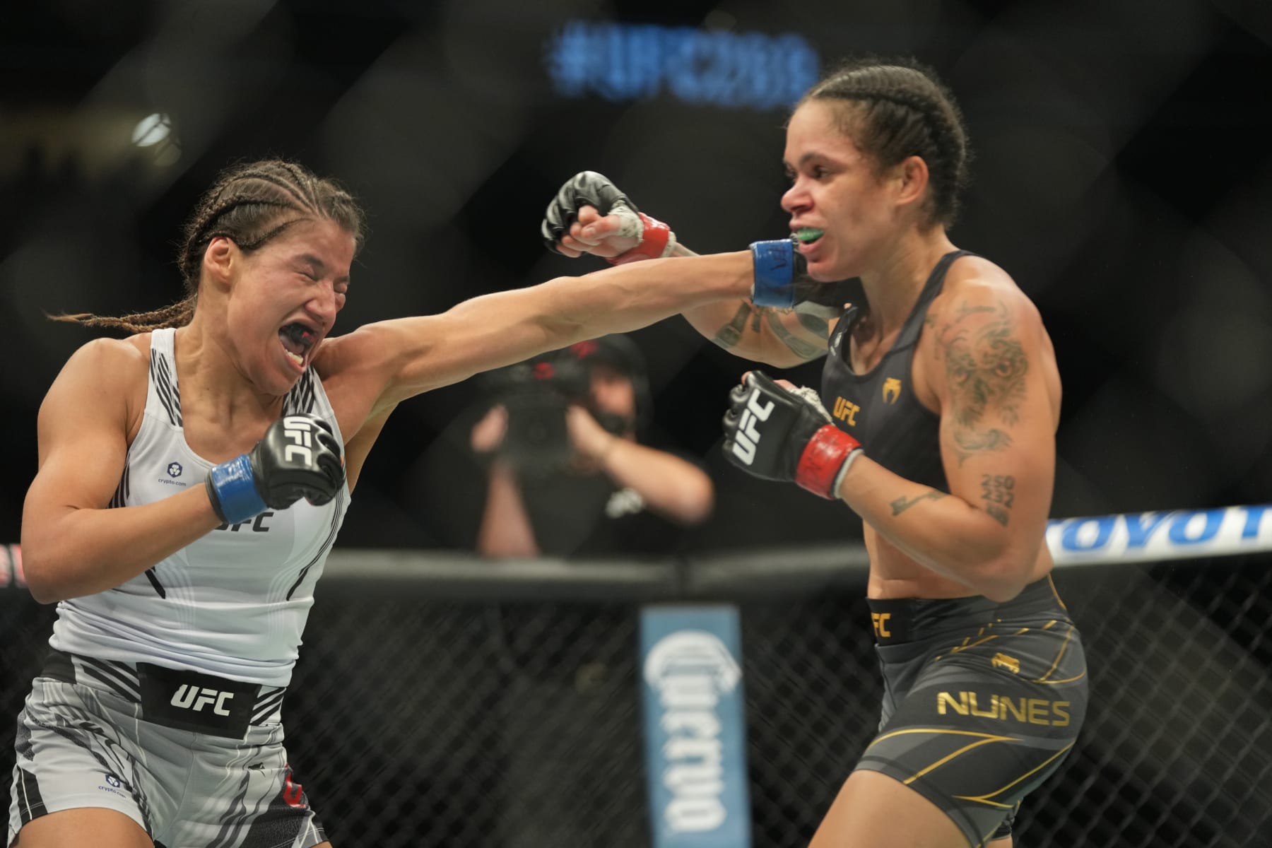 LAS VEGAS, NV - DECEMBER 11: (L-R) Julianna Peña punches Amanda Nunes in their womans bantamweight title fight during the UFC 269 on December 11, 2021, at T-Mobile Arena in Las Vegas, NV. (Photo by Louis Grasse/PxImages/Icon Sportswire via Getty Images)