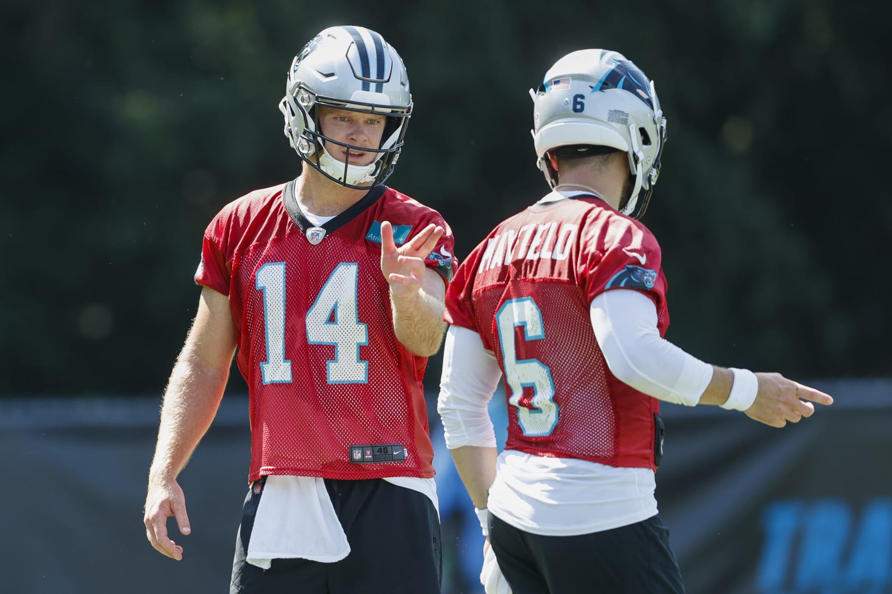 Carolina Panthers quarterback Sam Darnold (14) talks with quarterback Baker Mayfield (6) during drills at the NFL football team's training camp at Wofford College in Spartanburg, S.C., Thursday, July 28, 2022. (AP Photo/Nell Redmond)
