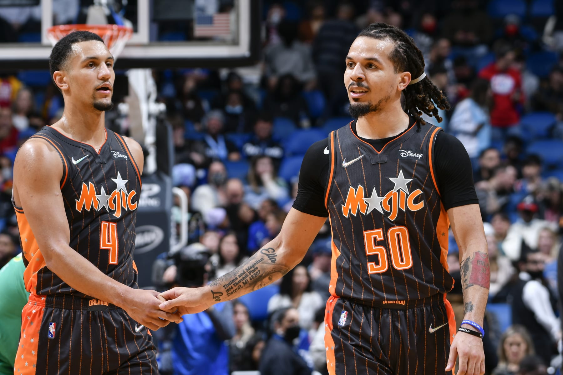 ORLANDO, FL - JANUARY 26: Jalen Suggs #4 of the Orlando Magic high fives Cole Anthony #50 of the Orlando Magic during the game against the LA Clippers on January 26, 2022 at Amway Center in Orlando, Florida. NOTE TO USER: User expressly acknowledges and agrees that, by downloading and or using this photograph, User is consenting to the terms and conditions of the Getty Images License Agreement. Mandatory Copyright Notice: Copyright 2022 NBAE (Photo by Fernando Medina/NBAE via Getty Images)
