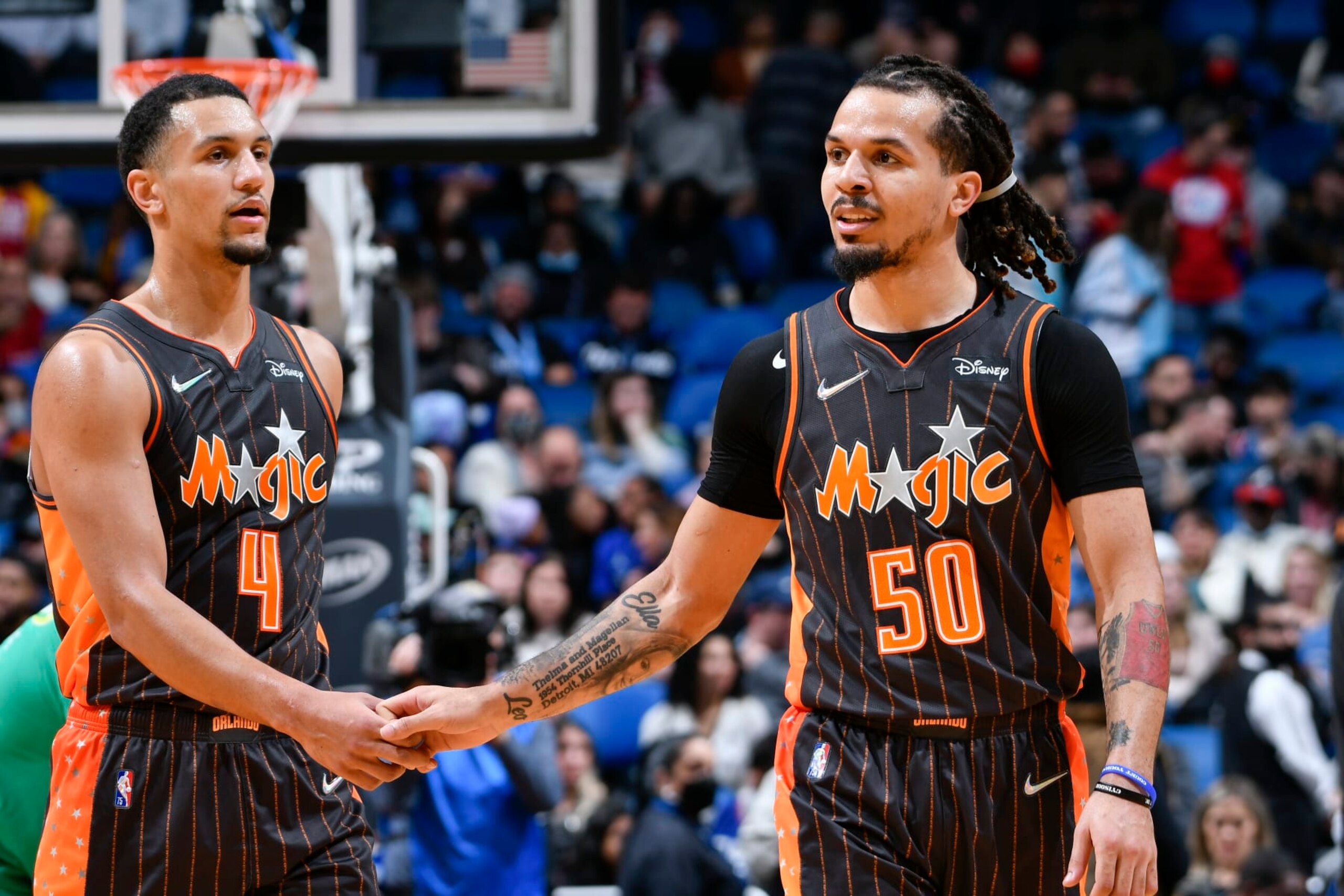 ORLANDO, FL - JANUARY 26: Jalen Suggs #4 of the Orlando Magic high fives Cole Anthony #50 of the Orlando Magic during the game against the LA Clippers on January 26, 2022 at Amway Center in Orlando, Florida. NOTE TO USER: User expressly acknowledges and agrees that, by downloading and or using this photograph, User is consenting to the terms and conditions of the Getty Images License Agreement. Mandatory Copyright Notice: Copyright 2022 NBAE (Photo by Fernando Medina/NBAE via Getty Images)