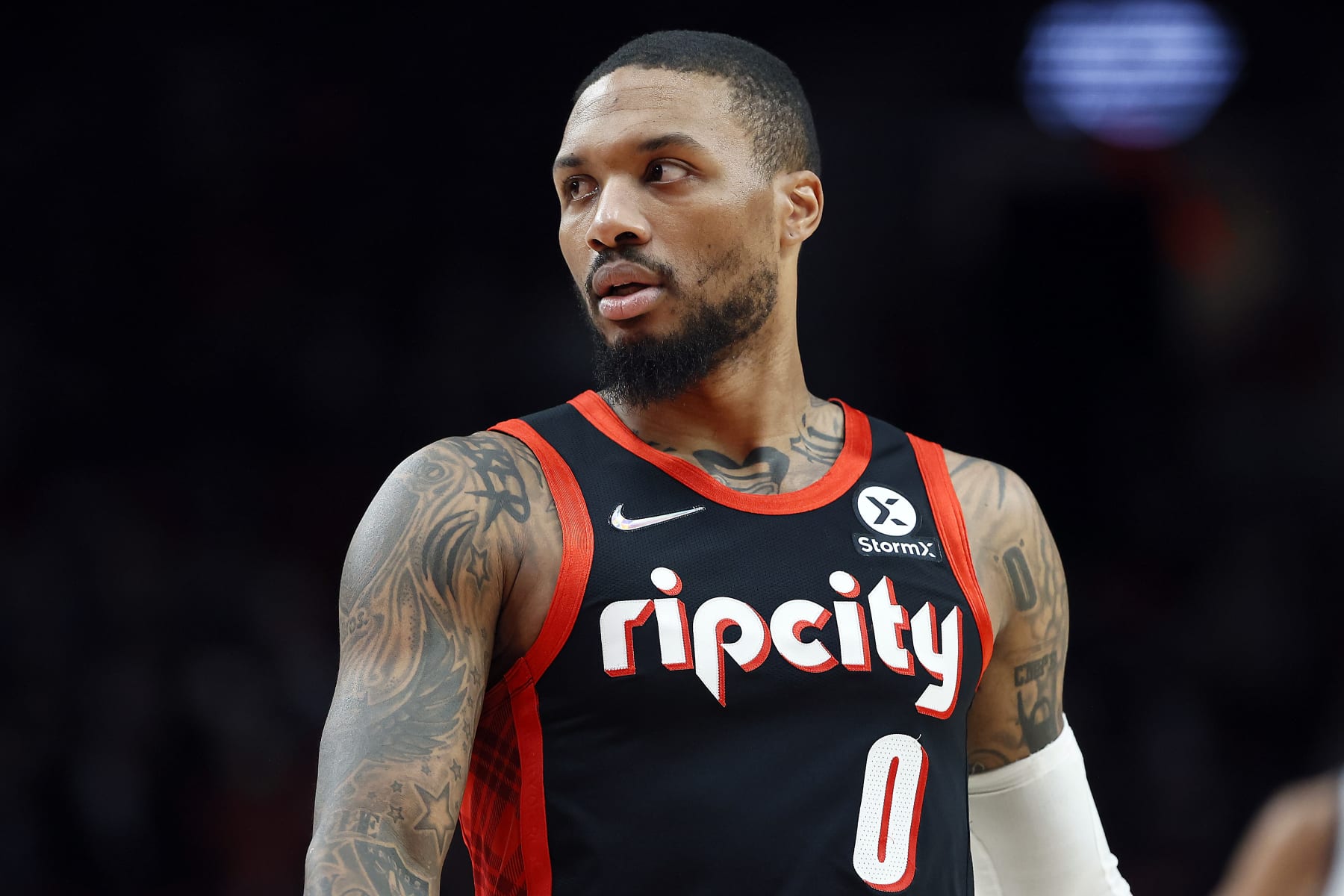 PORTLAND, OREGON - DECEMBER 29: Damian Lillard # 0 of the Portland Trail Blazers reacts during the first half against the Utah Jazz at Moda Center on December 29, 2021 in Portland, Oregon. NOTE TO USER: User expressly acknowledges and agrees that, by downloading and or using this photograph, User is consenting to the terms and conditions of the Getty Images License Agreement. (Photo by Soobum Im/Getty Images)