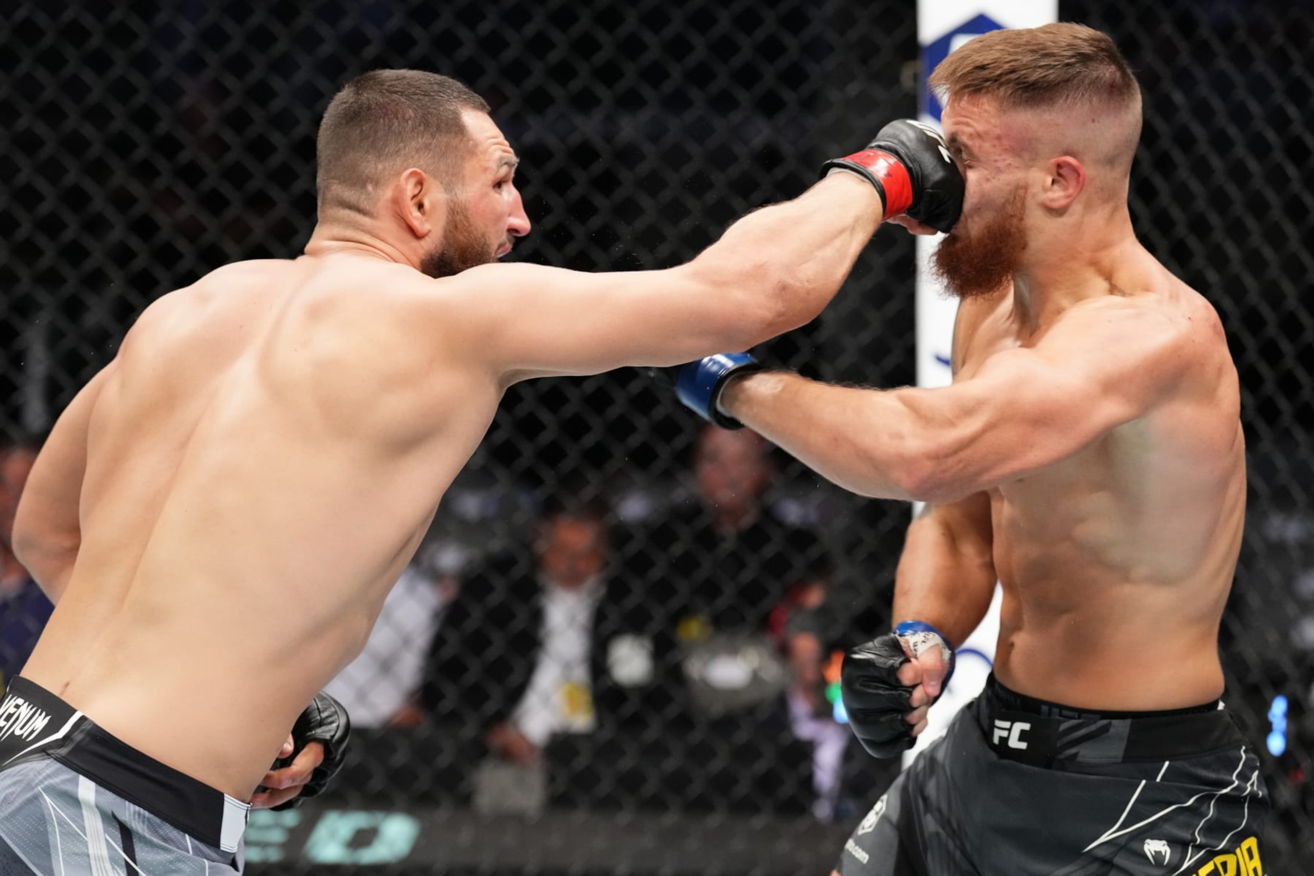 DALLAS, TEXAS - JULY 30: (L-R) Nicolae Negumereanu of Romania punches Ihor Potieria of Ukraine in a light heavyweight fight during the UFC 277 event at American Airlines Center on July 30, 2022 in Dallas, Texas. (Photo by Josh Hedges/Zuffa LLC)