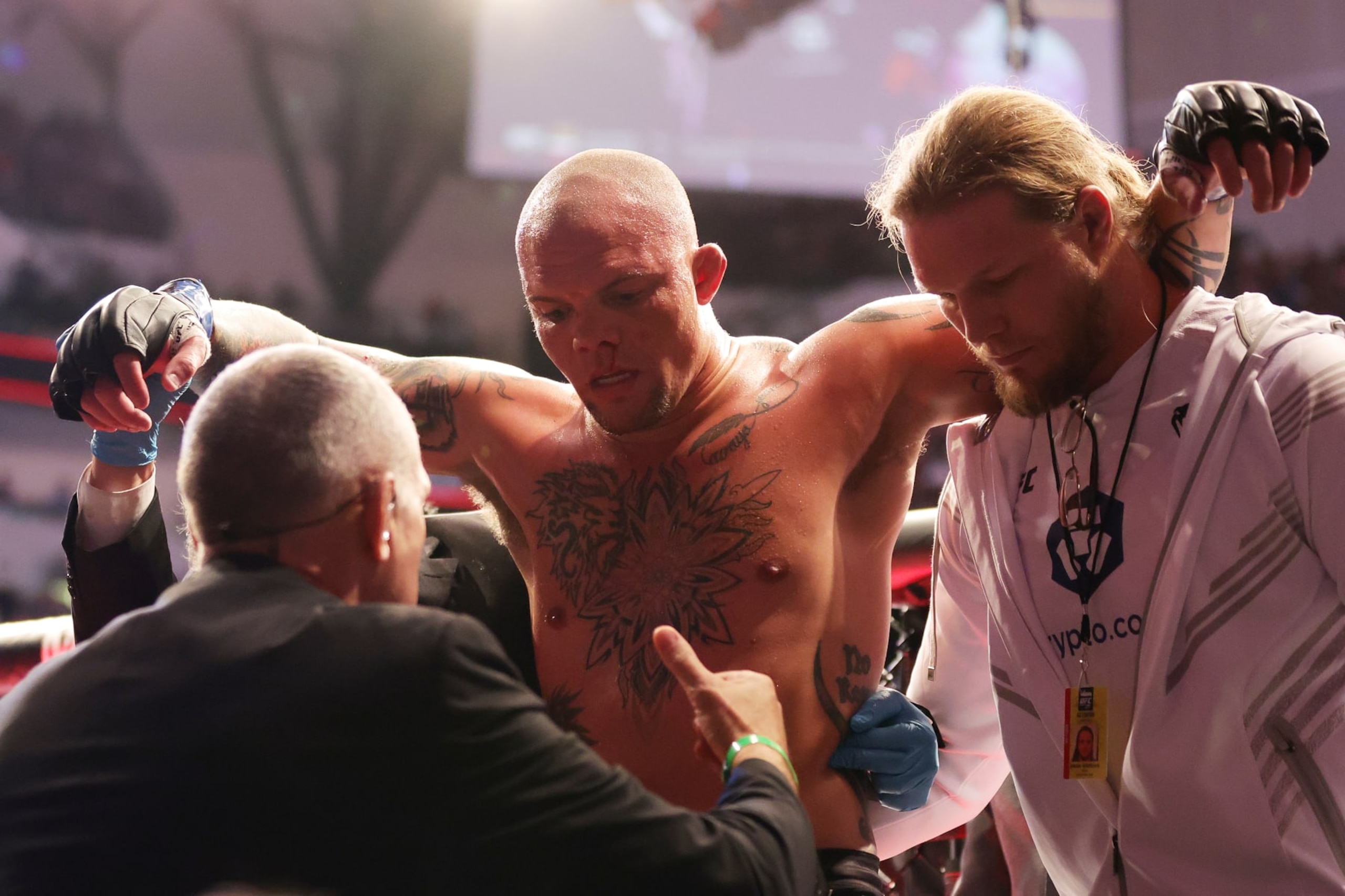 DALLAS, TEXAS - JULY 30: Anthony Smith is assisted off the octagon after his light heavyweight bout against Magomed Ankalaev of Russia during UFC 277 at American Airlines Center on July 30, 2022 in Dallas, Texas. Magomed Ankalaev won via a second round knockout. (Photo by Carmen Mandato/Getty Images)