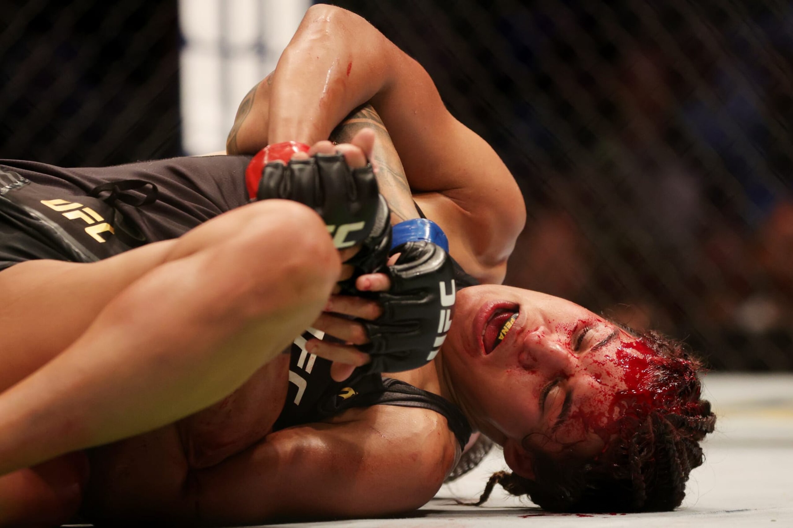 DALLAS, TEXAS - JULY 30: Julianna Pena reacts as she grapples with Amanda Nunes of Brazil in their bantamweight title bout during UFC 277 at American Airlines Center on July 30, 2022 in Dallas, Texas. (Photo by Carmen Mandato/Getty Images)