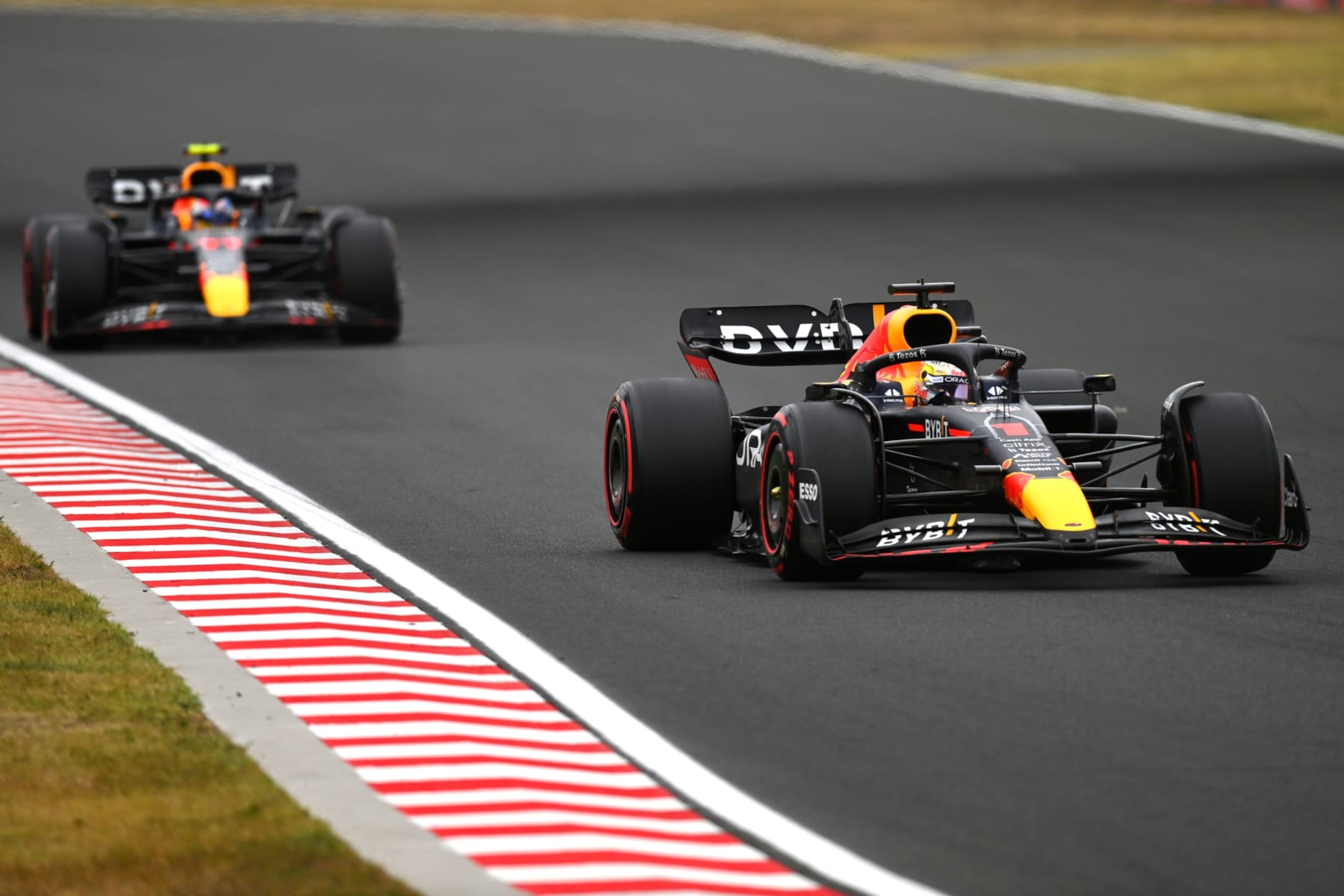 BUDAPEST, HUNGARY - JULY 31: Max Verstappen of the Netherlands driving the (1) Oracle Red Bull Racing RB18 leads Sergio Perez of Mexico driving the (11) Oracle Red Bull Racing RB18 during the F1 Grand Prix of Hungary at Hungaroring on July 31, 2022 in Budapest, Hungary. (Photo by Dan Mullan/Getty Images)