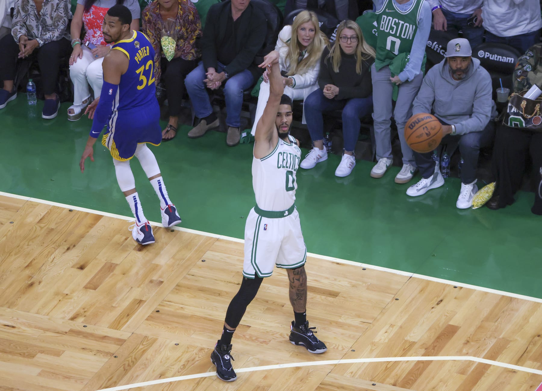 Boston - June 16: Boston Celtics forward Jayson Tatum (0) and Golden State Warriors forward Otto Porter Jr. (32) watch the flight of Tatums made three point basket during first quarter action. The Boston Celtics hosted the Golden State Warriors for Game Six of the NBA Finals at the TD Garden in Boston on June 17, 2022. (Photo by Matthew J. Lee/The Boston Globe via Getty Images)
