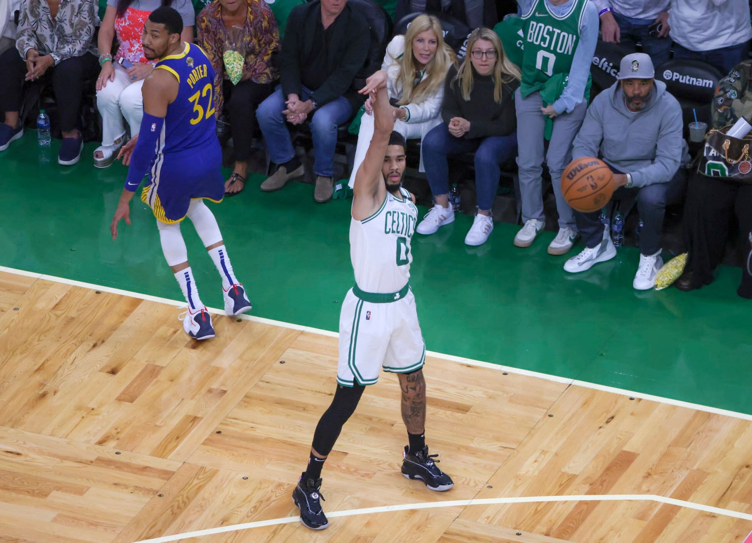Boston - June 16: Boston Celtics forward Jayson Tatum (0) and Golden State Warriors forward Otto Porter Jr. (32) watch the flight of Tatums made three point basket during first quarter action. The Boston Celtics hosted the Golden State Warriors for Game Six of the NBA Finals at the TD Garden in Boston on June 17, 2022. (Photo by Matthew J. Lee/The Boston Globe via Getty Images)