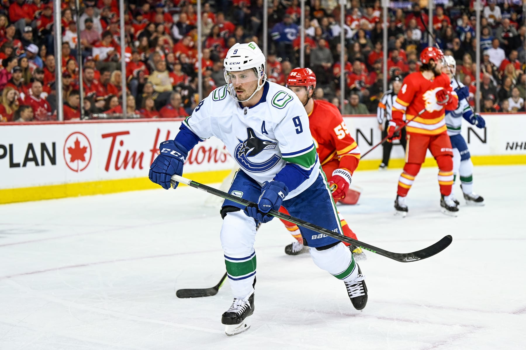 CALGARY, AB - APRIL 23: Vancouver Canucks Center J.T. Miller (9) skates after the puck during the first period of an NHL game where the Calgary Flames hosted the Vancouver Canucks on April 23, 2022, at the Scotiabank Saddledome in Calgary, AB. (Photo by Brett Holmes/Icon Sportswire via Getty Images)