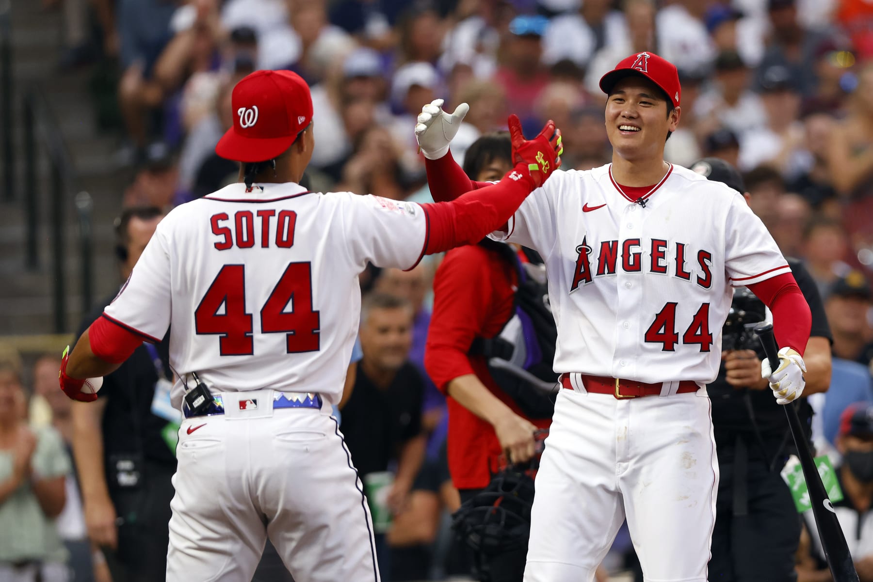 DENVER, COLORADO - JULY 12:Juan Soto #22 of the Washington Nationals high-fives Shohei Ohtani #17 of the Los Angeles Angels  during the 2021 T-Mobile Home Run Derby at Coors Field on July 12, 2021 in Denver, Colorado. (Photo by Justin Edmonds/Getty Images)
