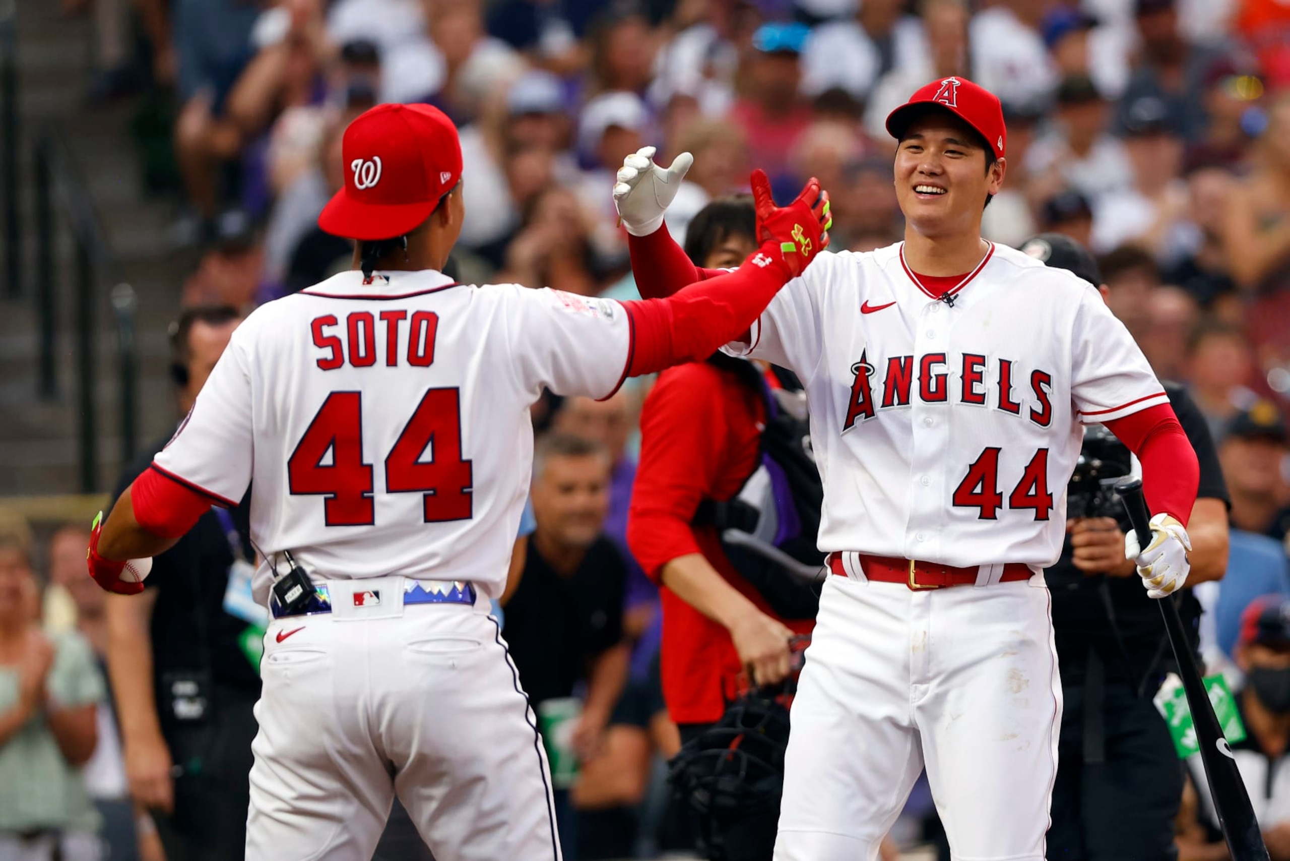 DENVER, COLORADO - JULY 12:Juan Soto #22 of the Washington Nationals high-fives Shohei Ohtani #17 of the Los Angeles Angels  during the 2021 T-Mobile Home Run Derby at Coors Field on July 12, 2021 in Denver, Colorado. (Photo by Justin Edmonds/Getty Images)