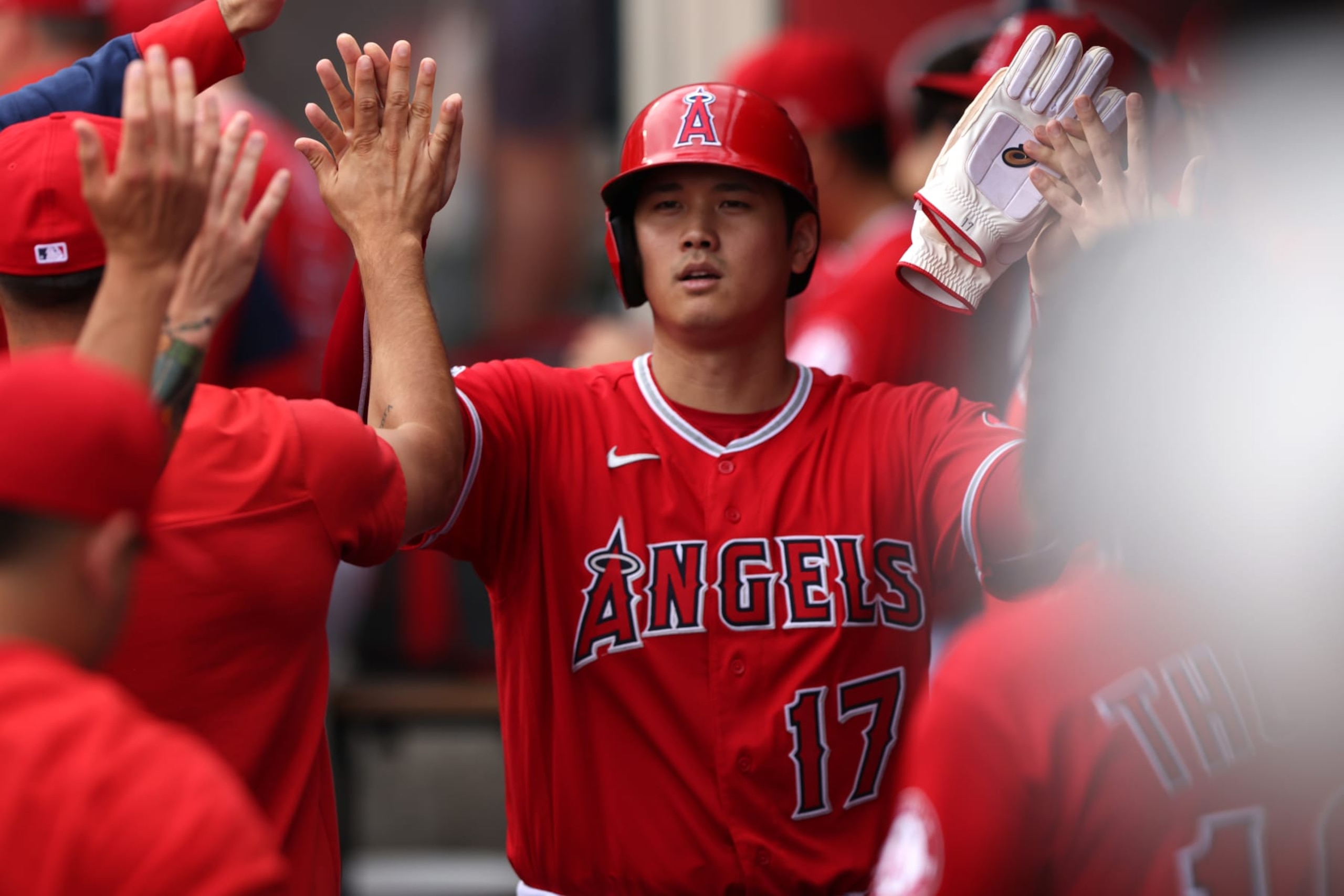 ANAHEIM, CALIFORNIA - JULY 31: Shohei Ohtani #17 of the Los Angeles Angels celebrates in the dugout after scoring a run in the first inning against the Texas Rangers at Angel Stadium of Anaheim on July 31, 2022 in Anaheim, California. (Photo by Katharine Lotze/Getty Images)