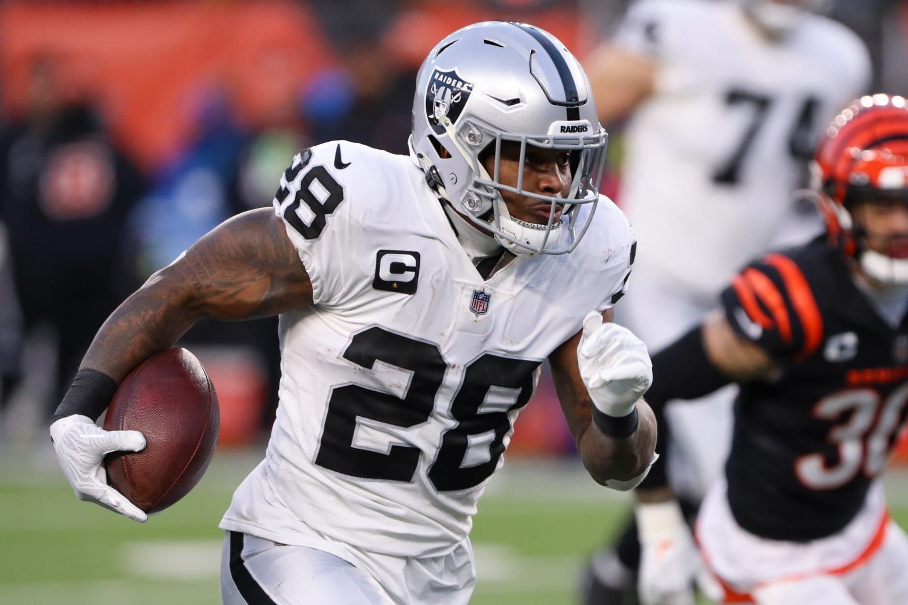 CINCINNATI, OH - JANUARY 15: Las Vegas Raiders running back Josh Jacobs (28) carries the ball during the Wild Card game against the Las Vegas Raiders and the Cincinnati Bengals on January 15, 2022, at Paul Brown Stadium in Cincinnati, OH. (Photo by Ian Johnson/Icon Sportswire via Getty Images)